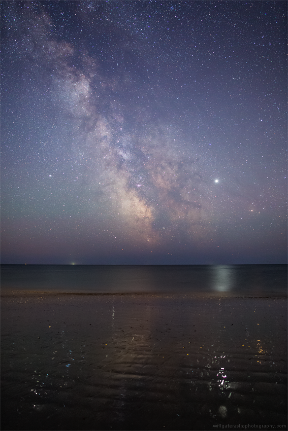 Celestial reflections - the glitter paths of Jupiter, Saturn and the summer stars in the wet sand of Charmouth Beach, UK
