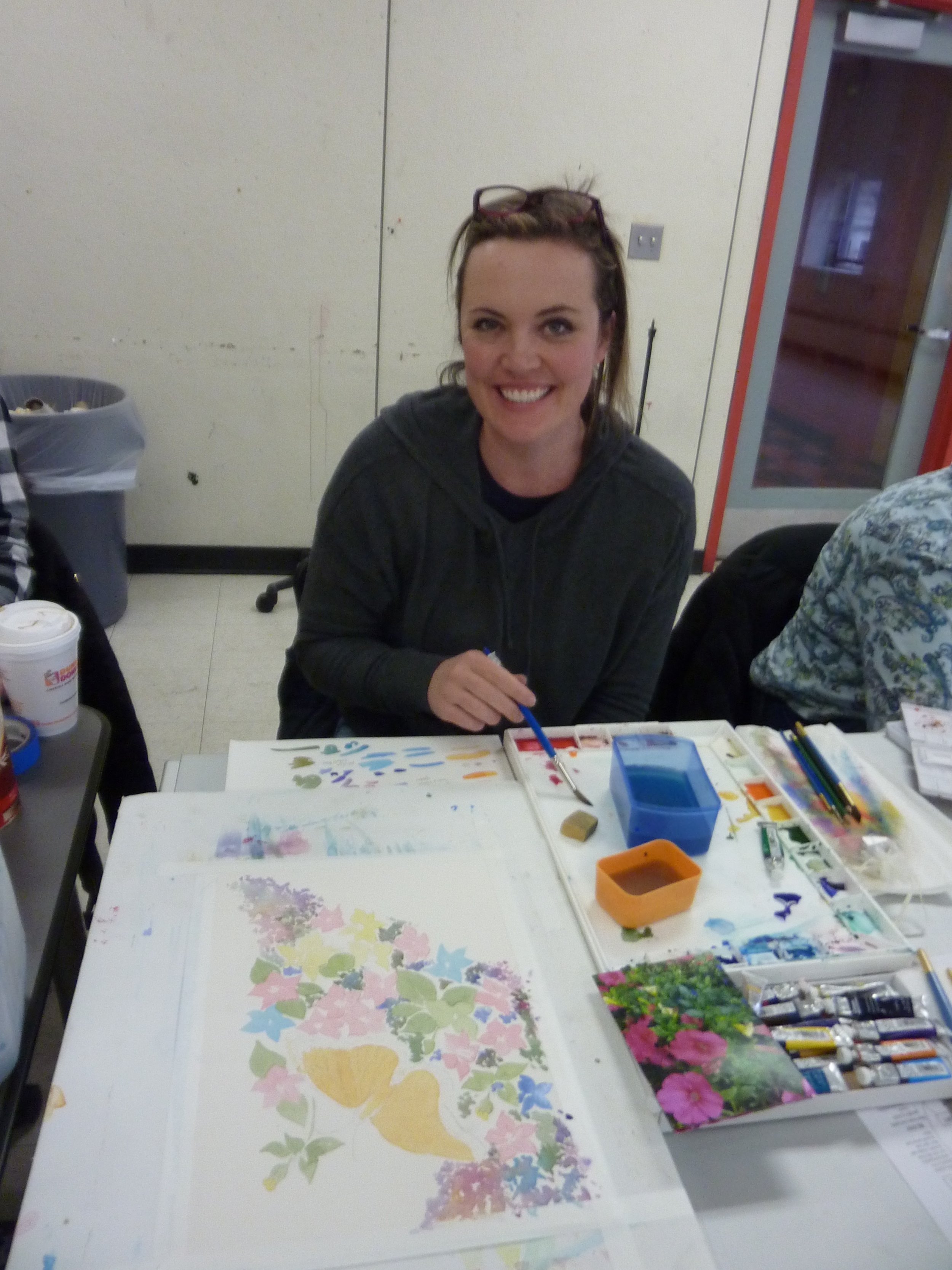 Elizabeth painted a floral illustration, beginning with lights, and layering glazes to create form.