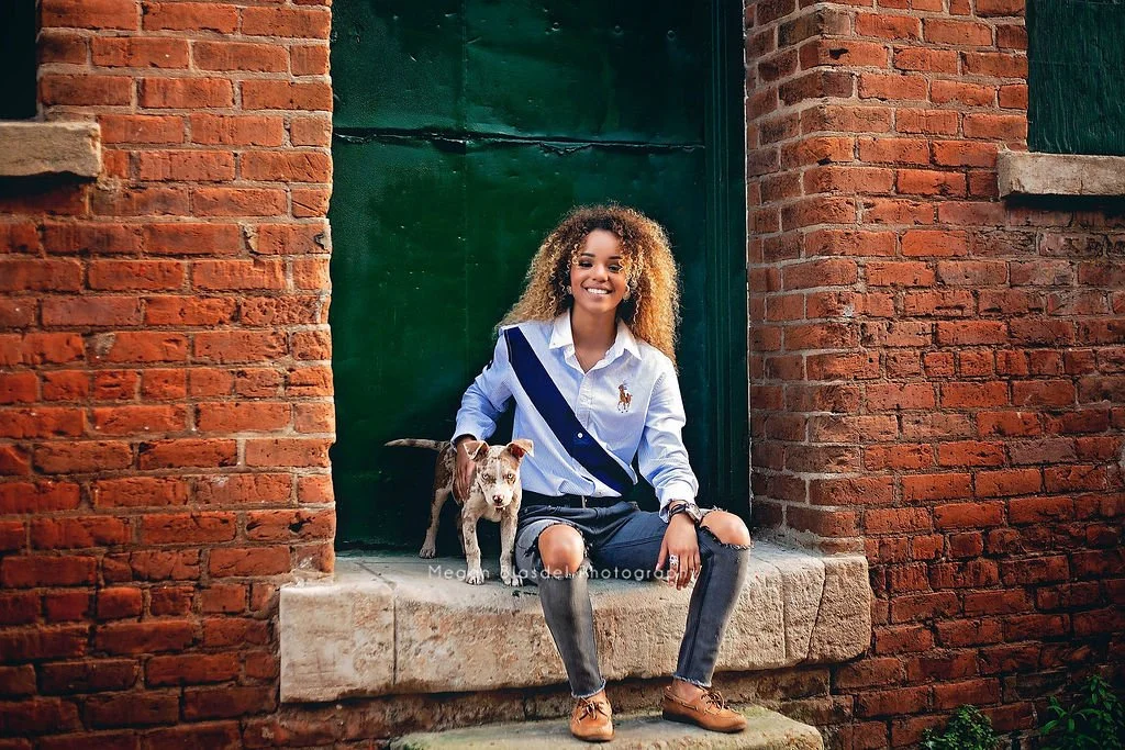 gorgeous POC senior girl with puppy in galveston alleyway