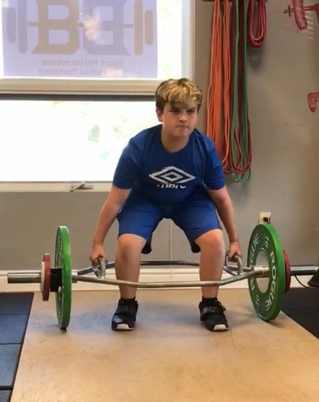 11-year-old Colby trap bar deadlifting 100lbs