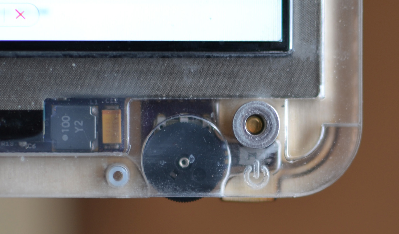 backlight capacitor & inductor, no longer under the screen. the on/off switch cover has a living hinge .