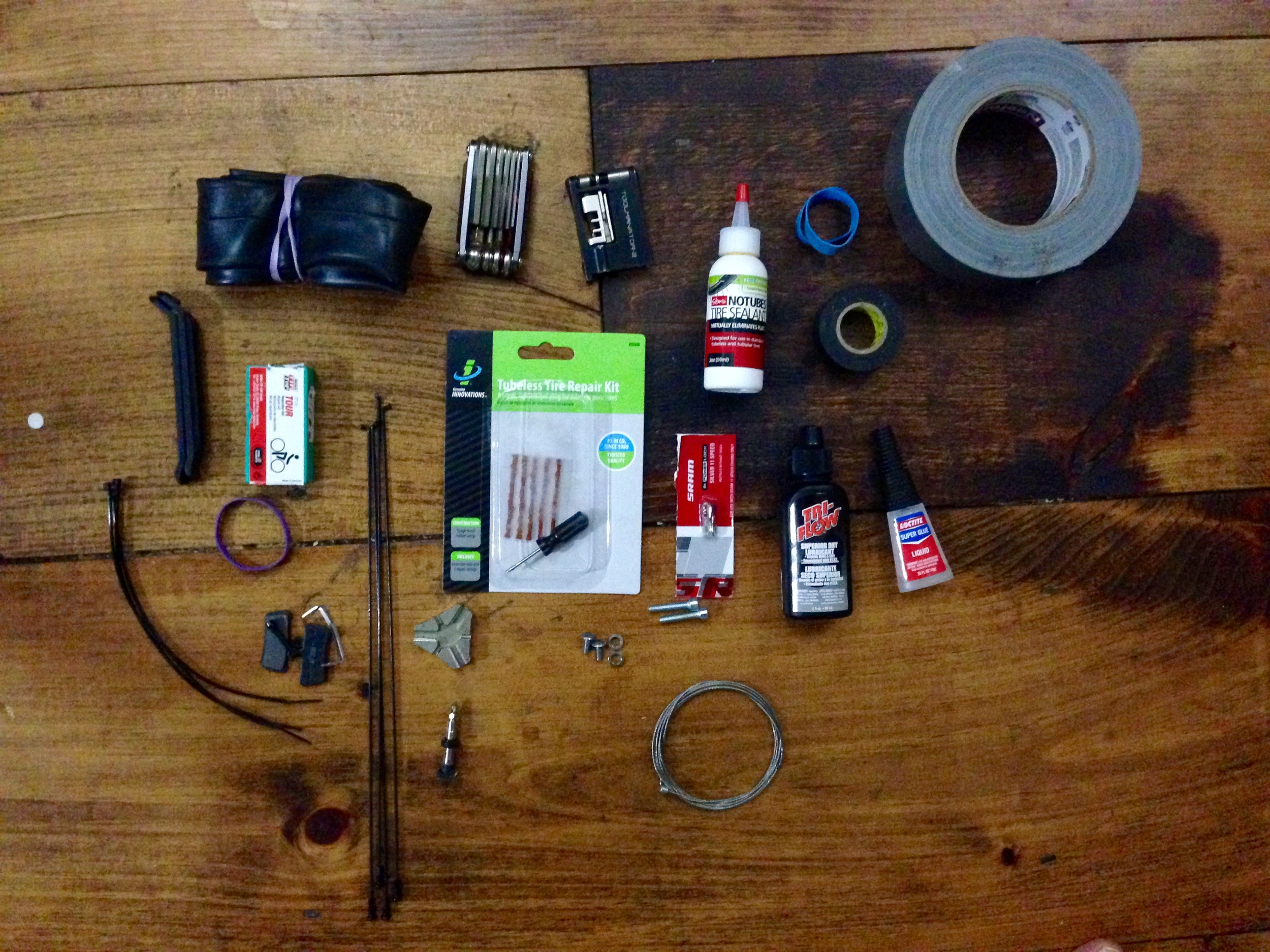 Bike repair knoll: bike tube, multi tool, chain break that someone almost broke, #stans, rubber bands, electrical and duct tape (yes I wrapped around my handlebars) tire lever (but I won't use them promise @tophervalenti ) patch kit, 3 x extra spokes, tubeless patch kit, master link for @srammtb 1 x 11 😍, chain lube, super glue, brake pads, zip ties, spoke wrench, extra valve/core, nuts, dérailleur cable.
