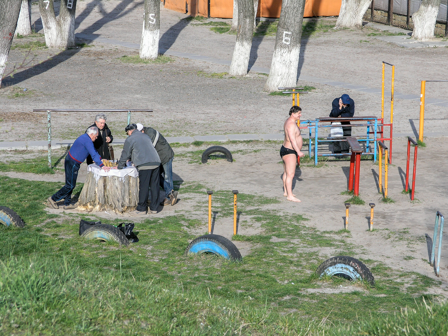  Men playing chess in a playground on ‘Hidropark’, an island in the middle of the Dnieper river in Kyiv. The island is a popular place for recreation in the summer months. 