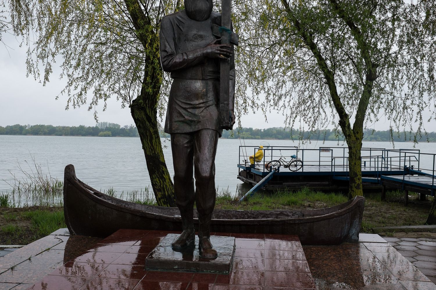  A man fishes in the Danube at Vilkovo near a statue commemorating early Lipovan settlers to the region. The Lipovans - Orthodox Old Believers - came to this corner of Ukraine after the schism of the Russian Orthodox Church, caused by the reforms of 