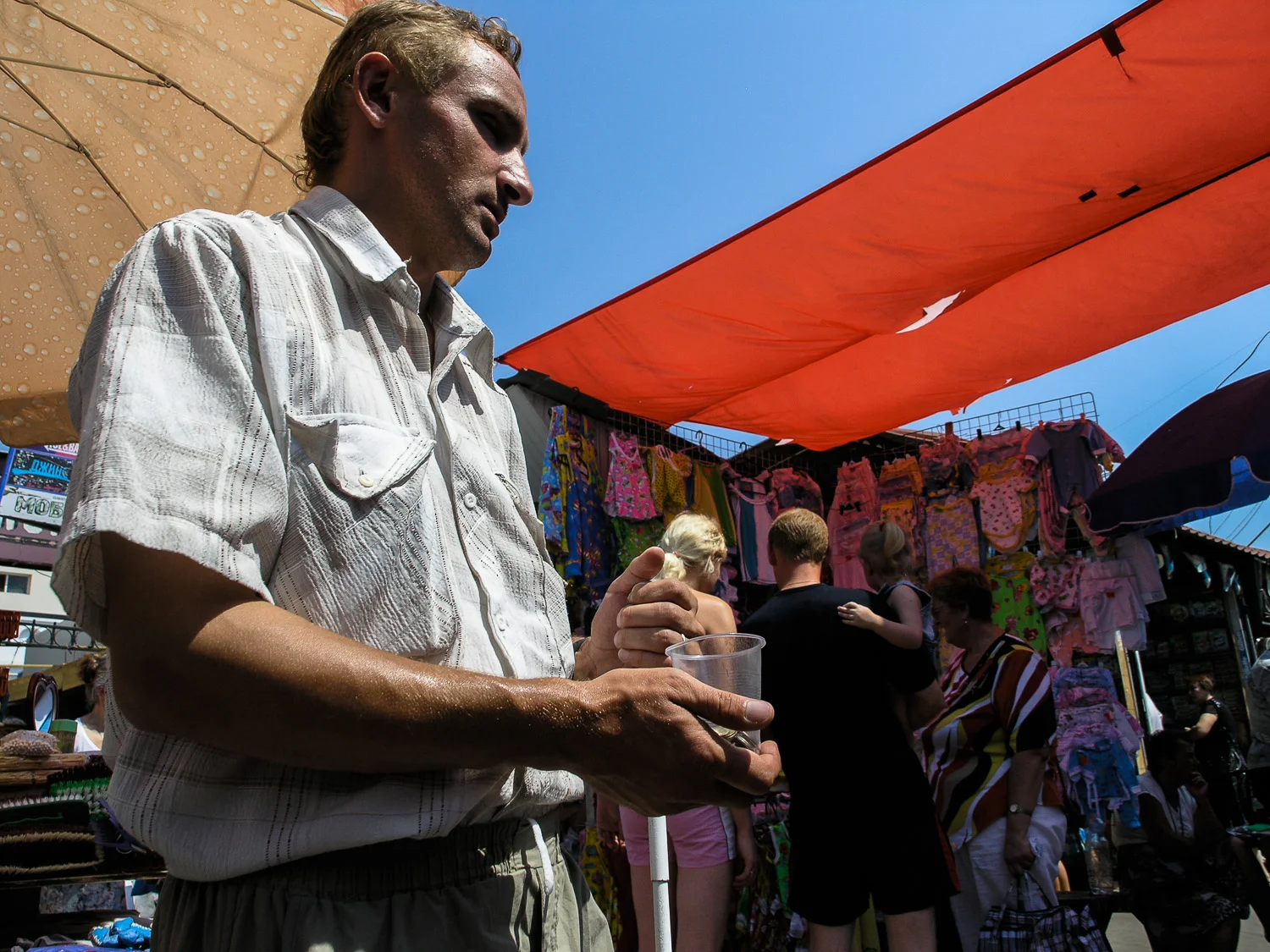 A disabled man begs for money in a market in Odessa.