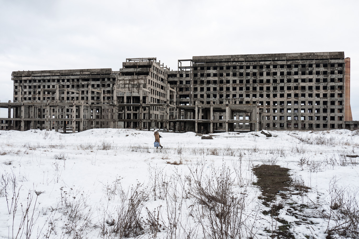  A woman walks past an abandoned building in Donetsk, east Ukraine. 