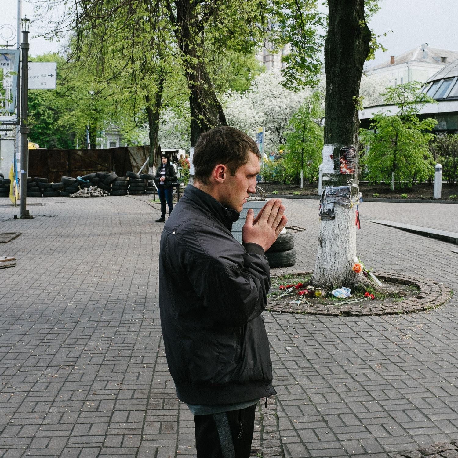  A man prays in front of a memorial to protesters killed in the February 2014 shootings on Kyiv’s Hrushevskoho Street, off Independence Square, April 2014. 