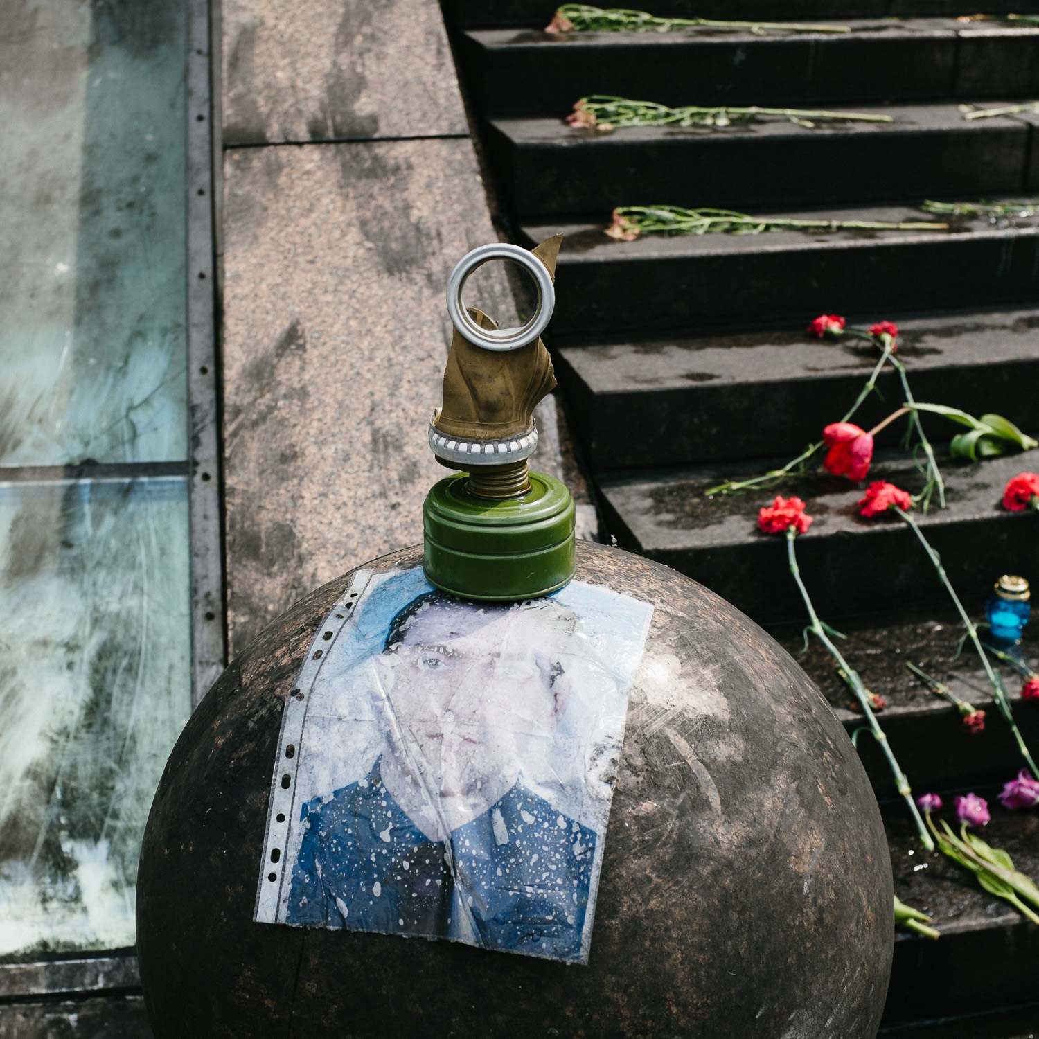  Part of a gas mask sits on top of a portrait of a man in Kyiv's Independence Square, April 2014. 