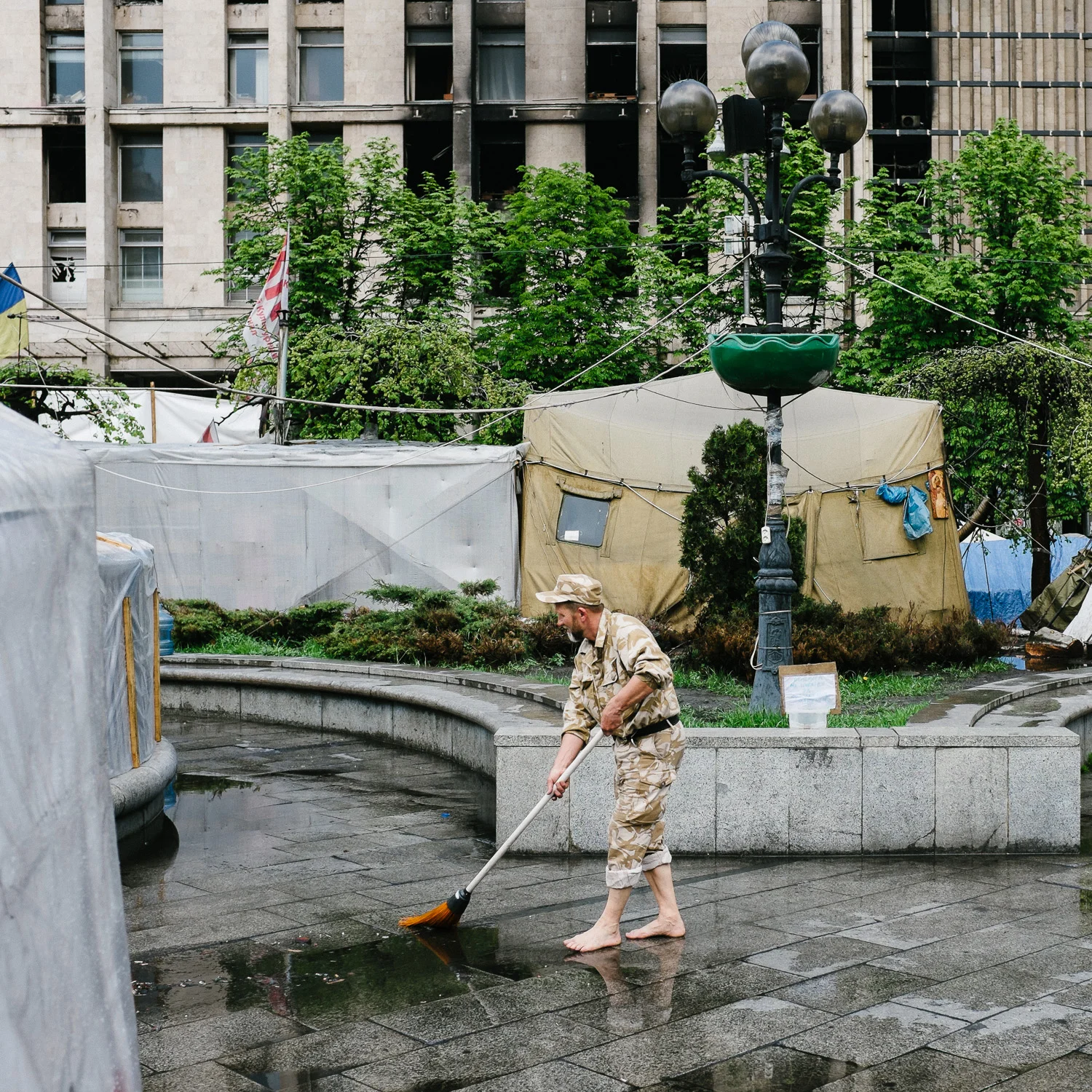 A man sweeps away water after rain in Independence Square, Kiev, April 2014.