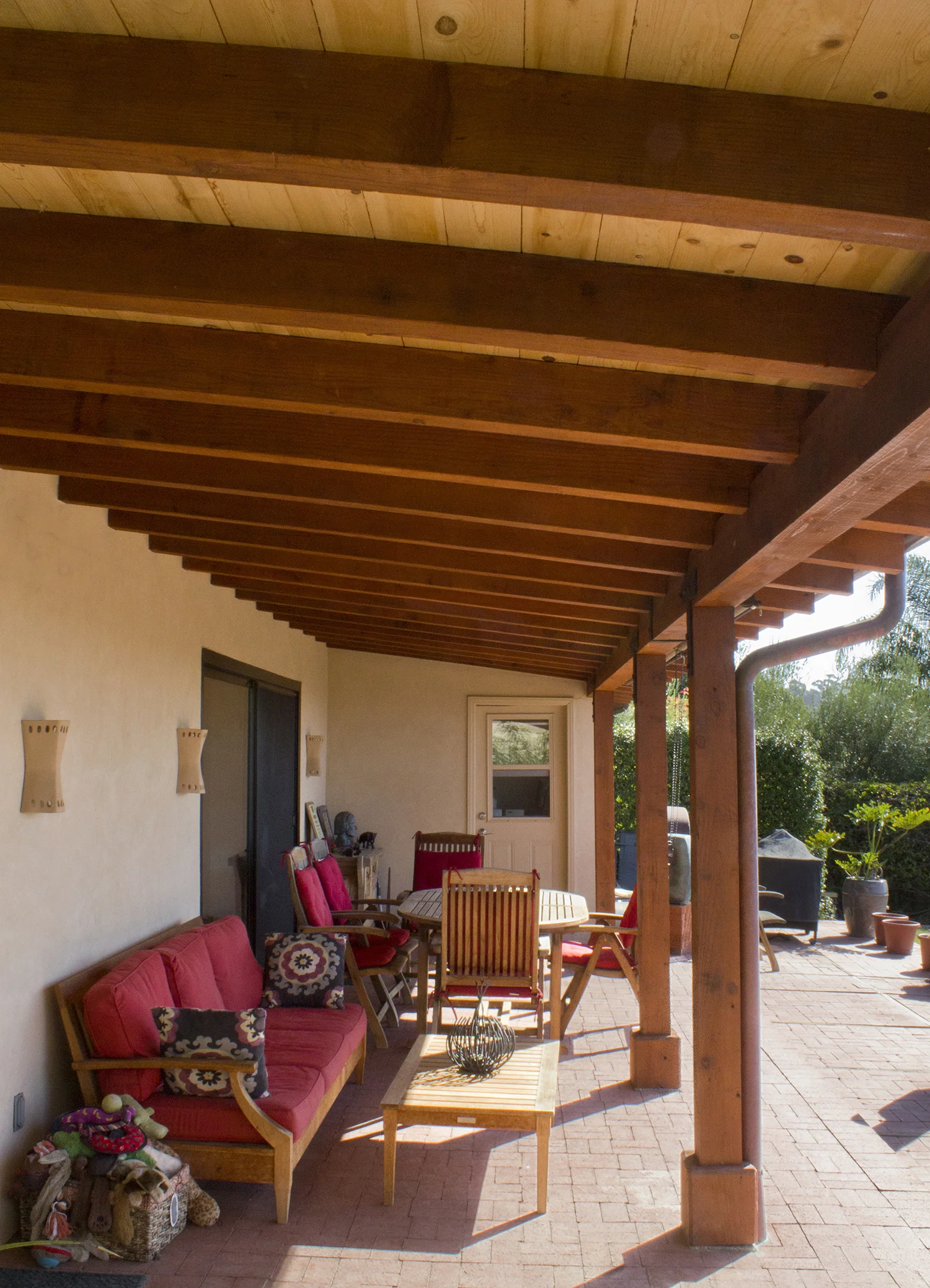 Expansive back patio with the continued exposed beams theme provides a space for entertaining and relaxing. 