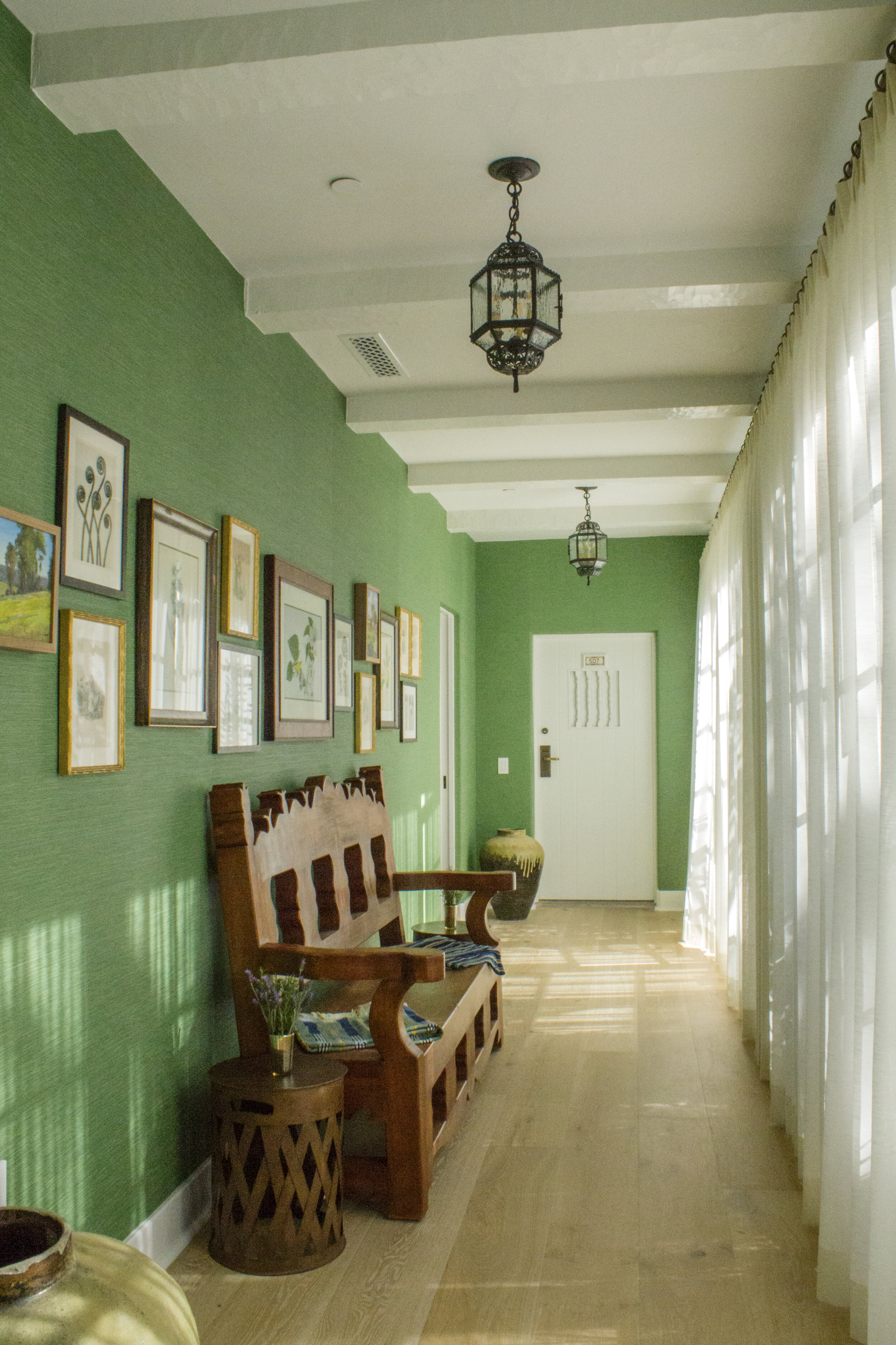 Cool green hallway, adding a dominate visual interest without overpowering the minimalist design.