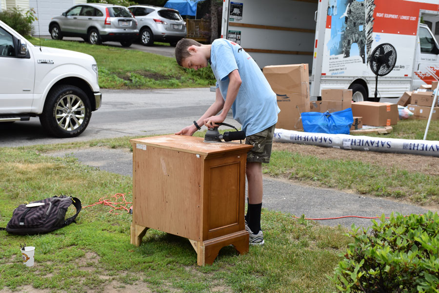   Aidan working hard to sand down the nightstand  