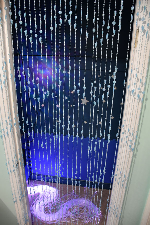 Light Sensory Zone featuring glow-n-the-dark dolphin beads, fiberoptic light strands, and ocean wave projector