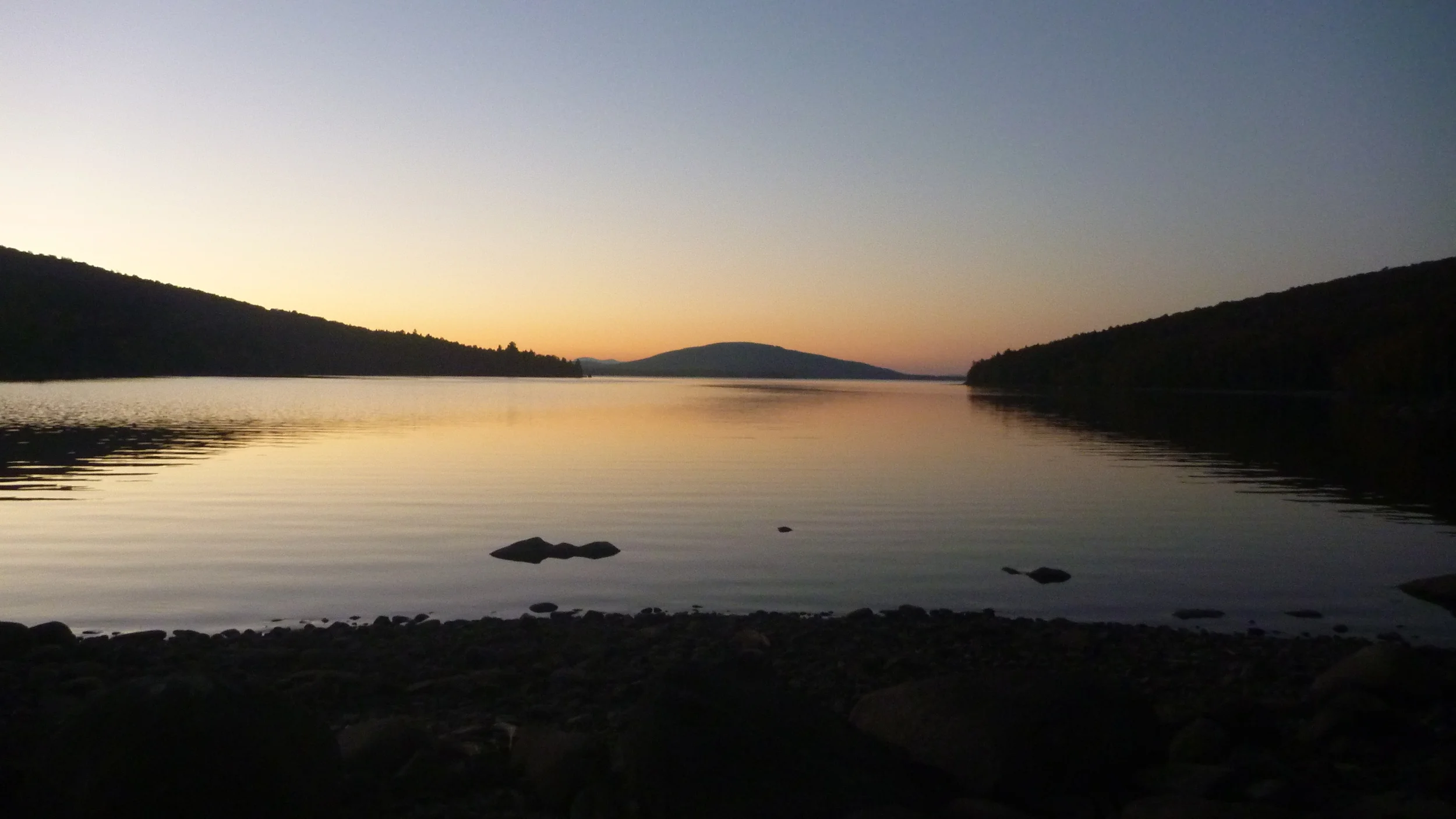 On the pebble beach at Flagstaff Lake