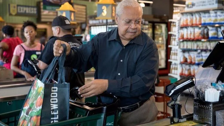 Addison Shields, 68, purchases groceries at the Englewood Whole Foods on Sept. 20, 2017, in Chicago. Shields took healthy cooking and eating classes at the store and says he was able to lose weight and reduce his blood sugar levels. (Erin Hooley / Chicago Tribune)