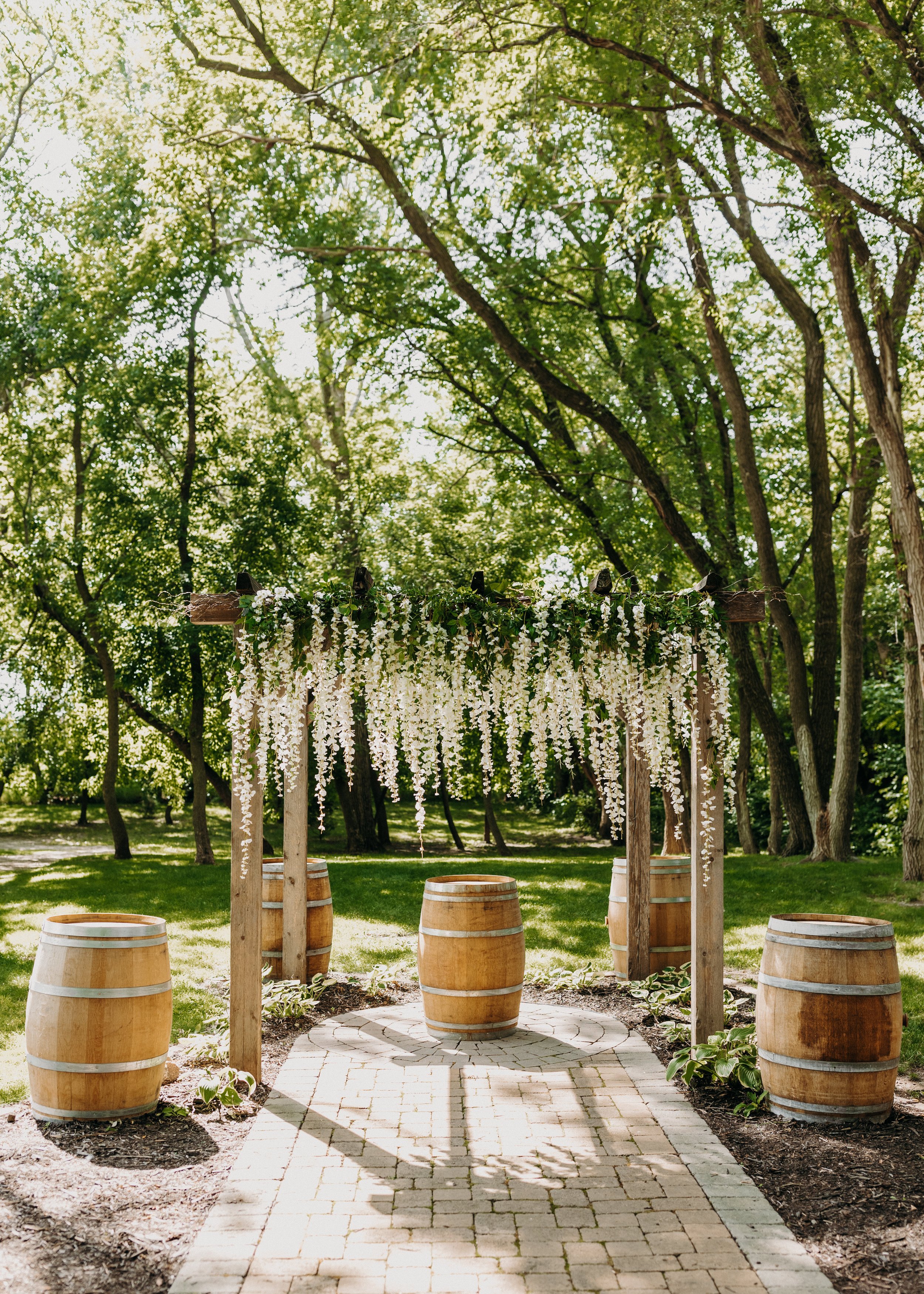 Wisteria floral arbor at an outdoor ceremony winery venue in Minnesota.