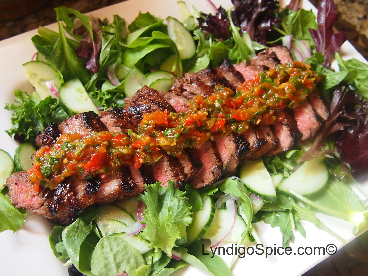 Grilled Steak with Spicy Red Pepper Relish mixed with organic cilantro
