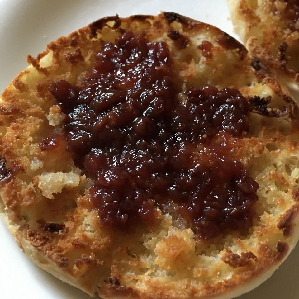 butter toasted english muffin with plum fruit spread