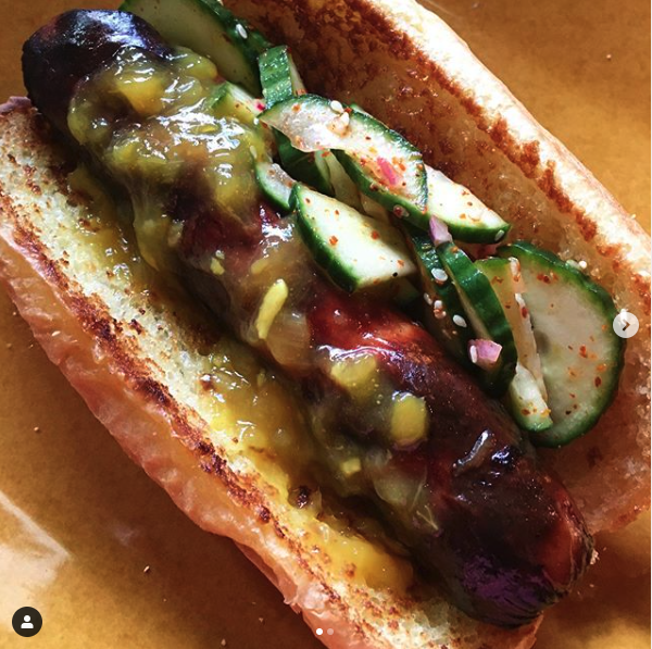 hot dog with roasted mango relish