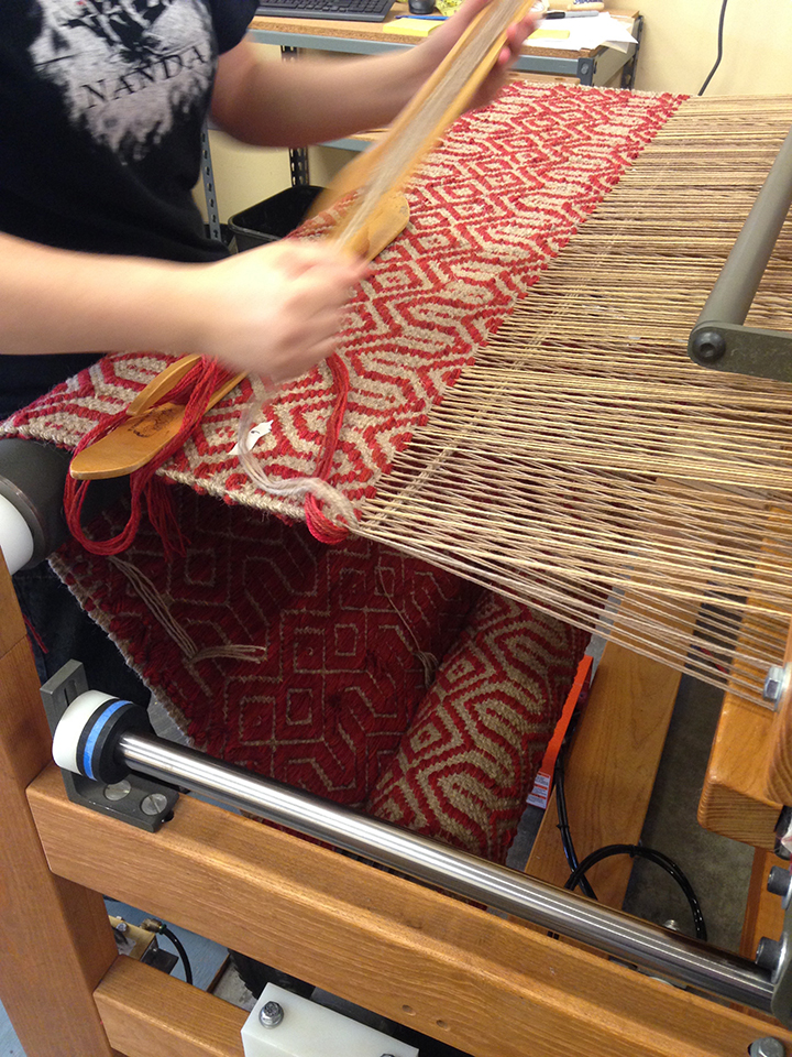 Kate weaving at True North Textiles.