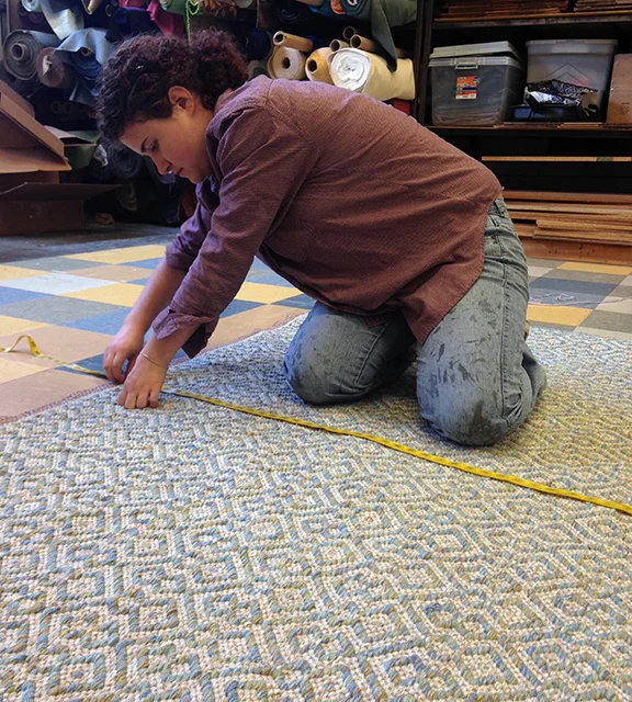 Kate measuring shadow Weave Aqua handwoven rug.