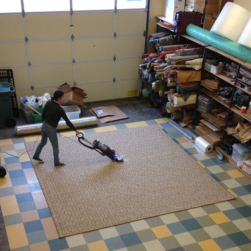 Meg vacuuming finished rug.