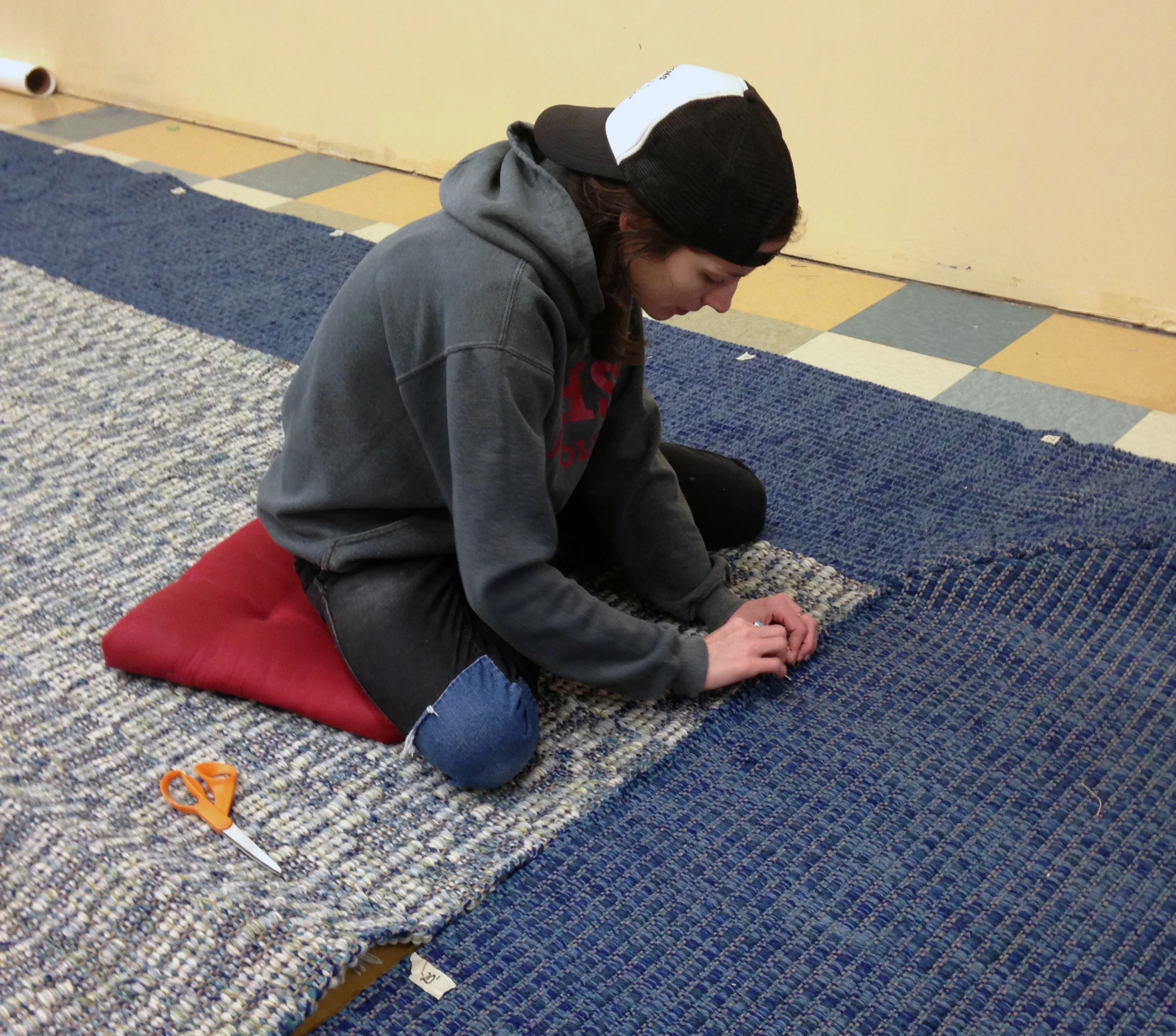 Meg seaming the border on the mitered-corner rug.