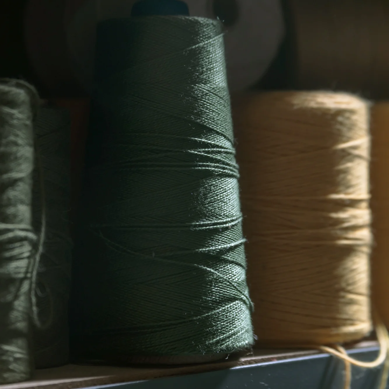 A spool of our hunter green cotton yarn