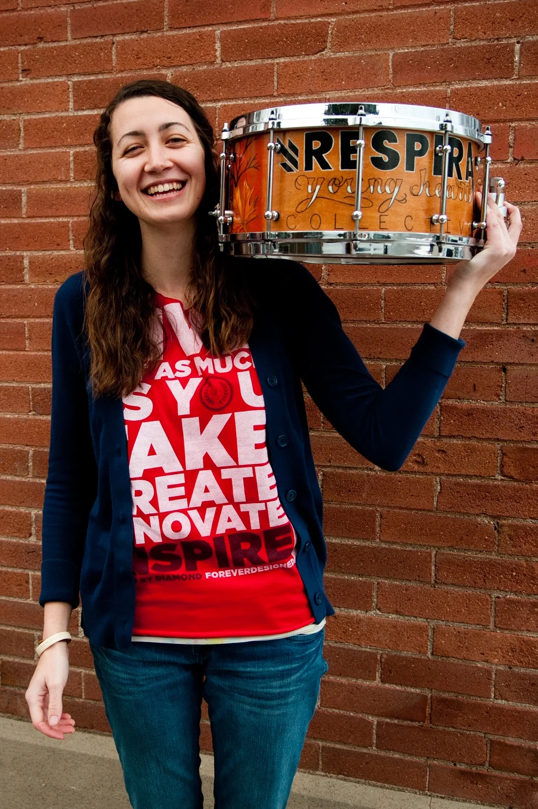 Liz Aponte, female drummer and entrepreneur, poses with a handmade drum