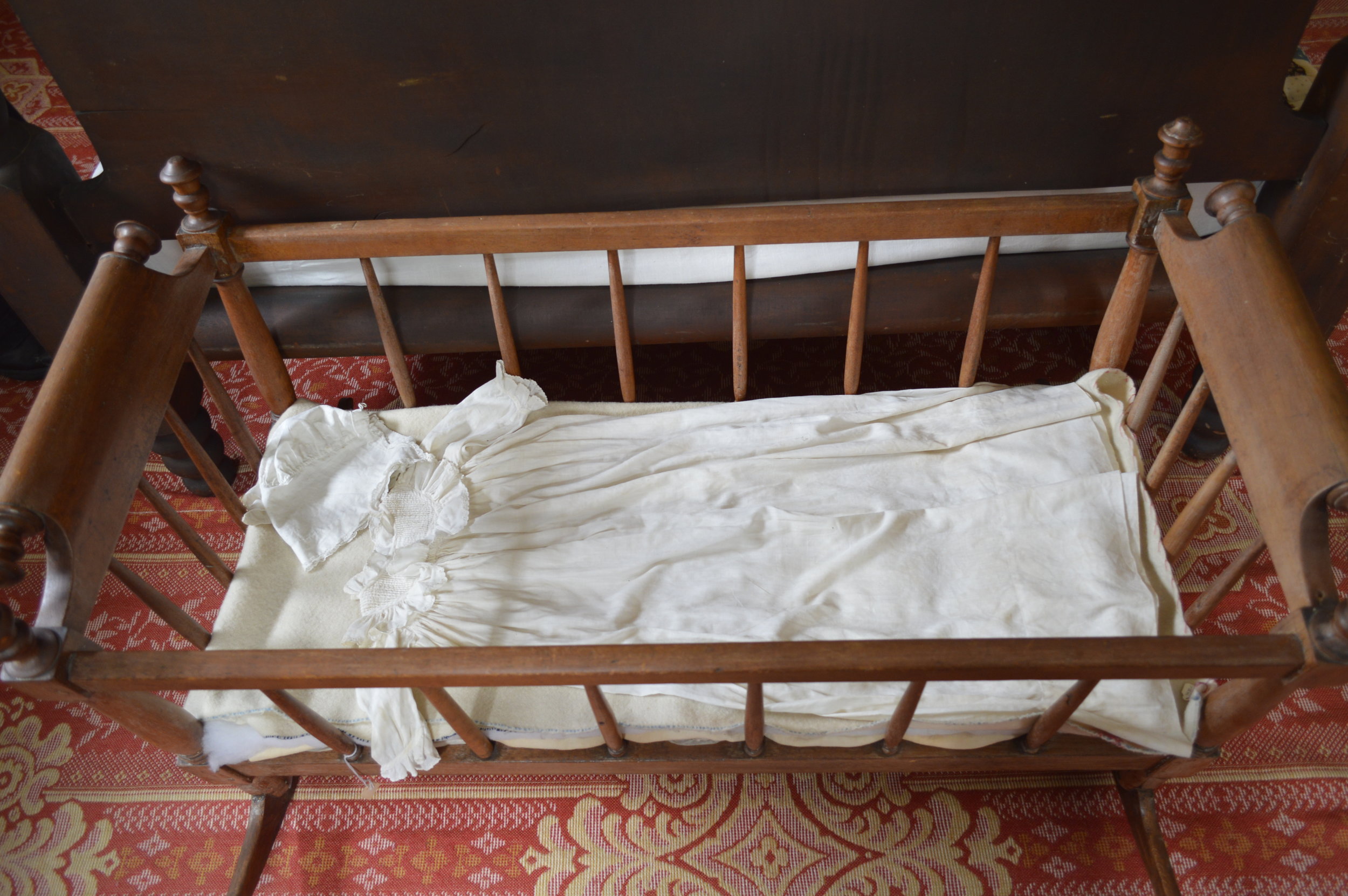 Next to the parents’ bed was a rocking cradle with a lace embroidered cap and gown for the baby. (Copy)