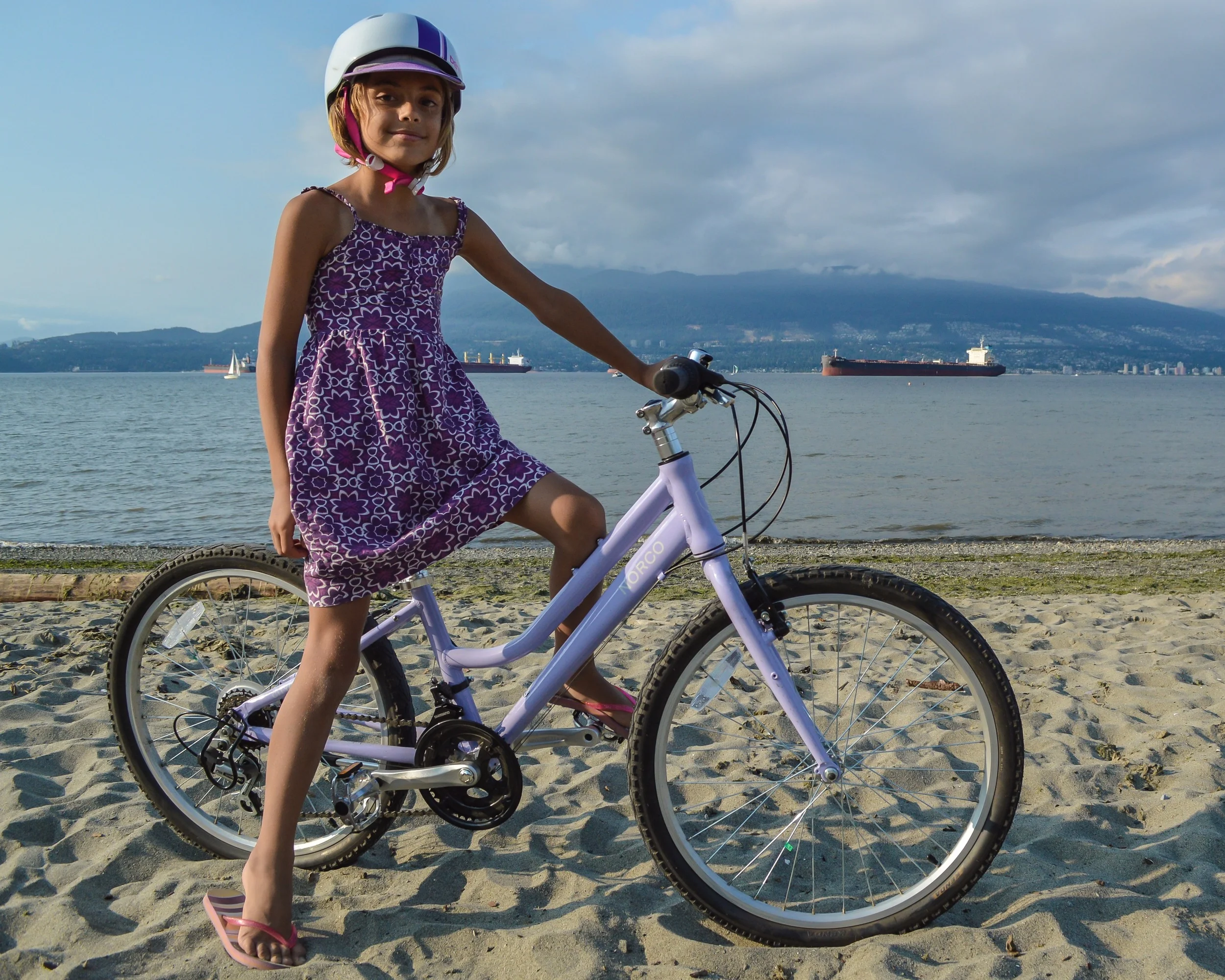 Even after riding many miles this summer, she's still happy to get on her bike again and again.