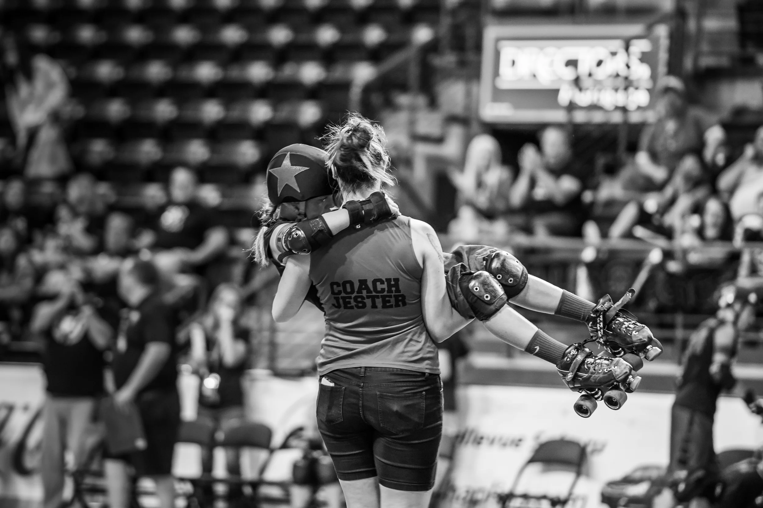 Jester helping M'n'M (of the Cherry Bomb Brawlers from Spokane) off the track after a bad fall, during the JRDA Championships - 2015