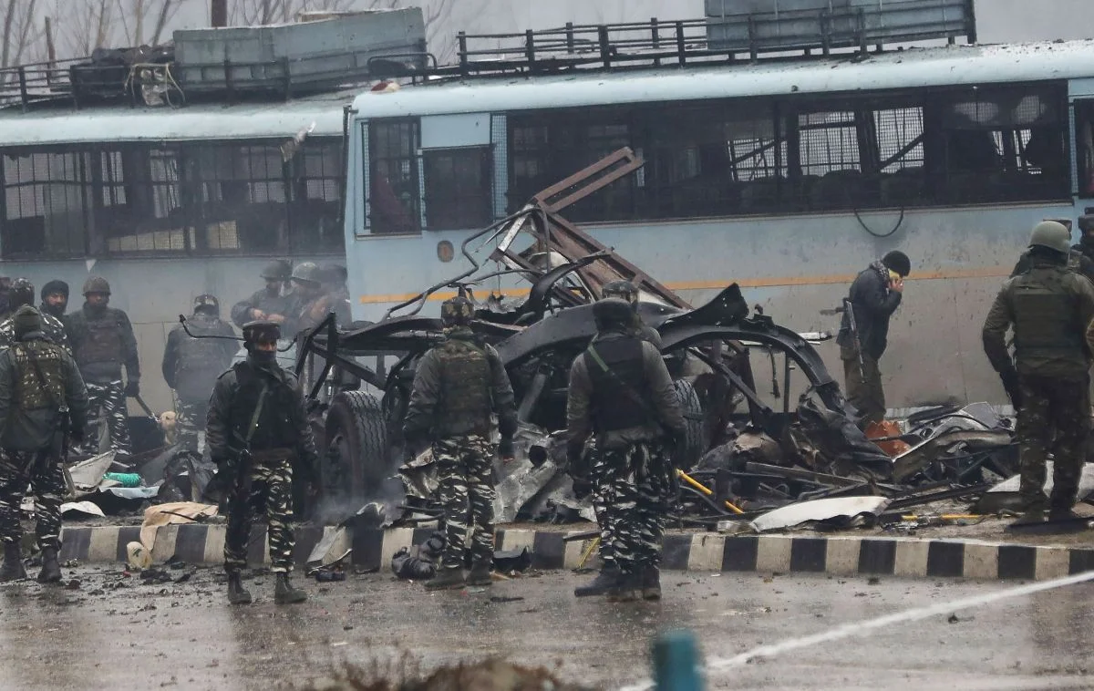 Indian security forces inspect the remains of a vehicle following a bomb explosion on a paramilitary Central Reserve Police Force convoy in Kashmir on Feb. 14, 2019. (Credit: STR/AFP/Getty Images )