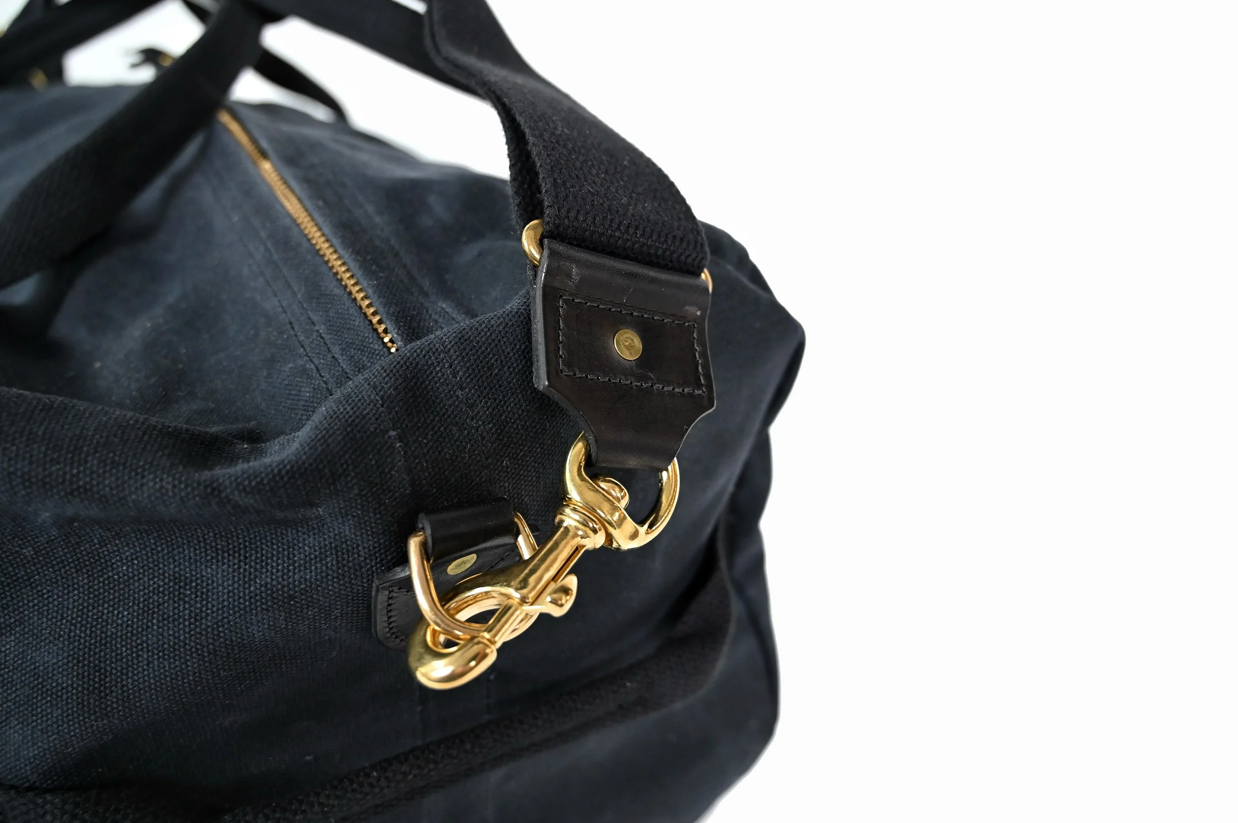 Waxed_black_duffle_bag_side_brass.jpg