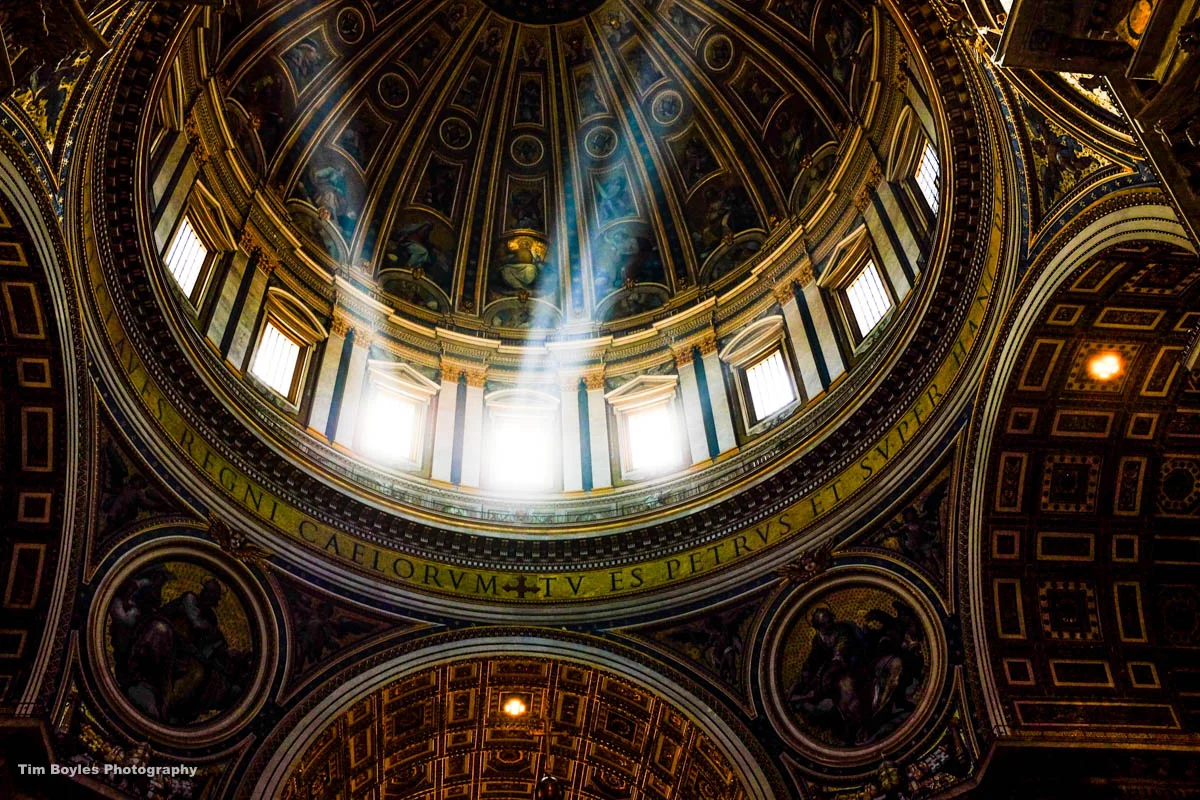 Light shines through the dome of St. Peter's Basilica in Rome, Italy in June, 2016.
