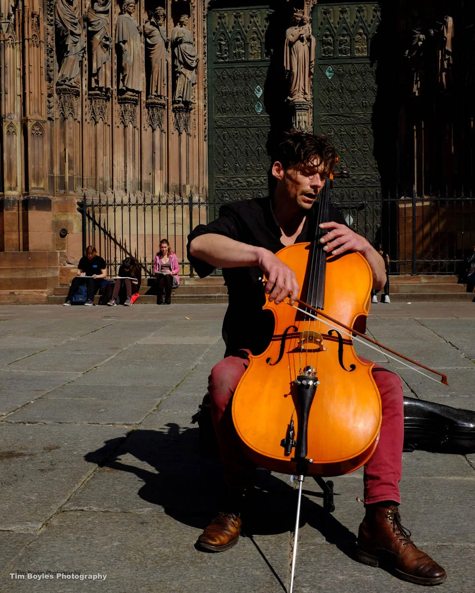 A man plays the cello outside a Church in Rome, Italy.