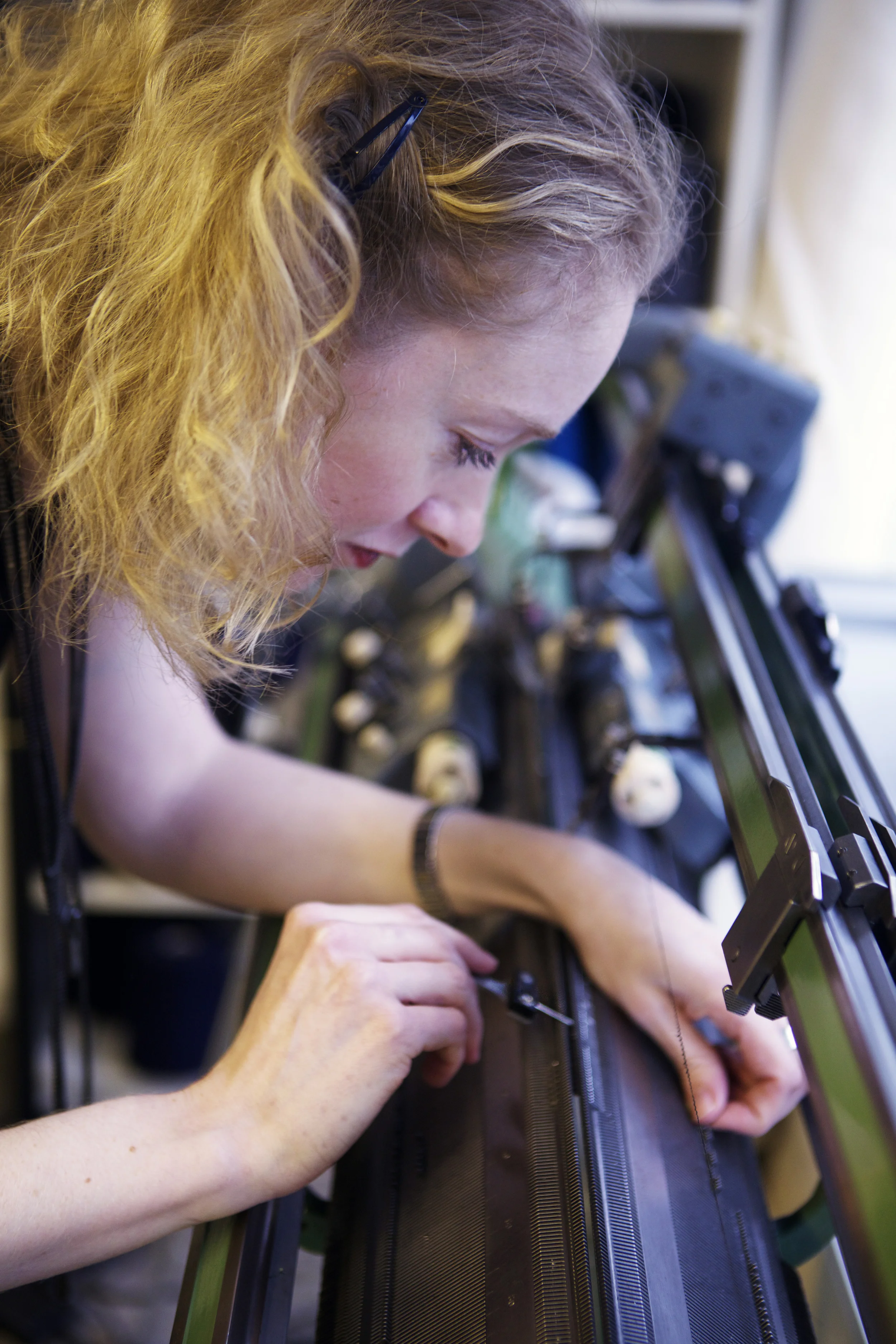 Layla at work on the 12 gauge vintage industrial knitting machine Photography Georgia Kuhn