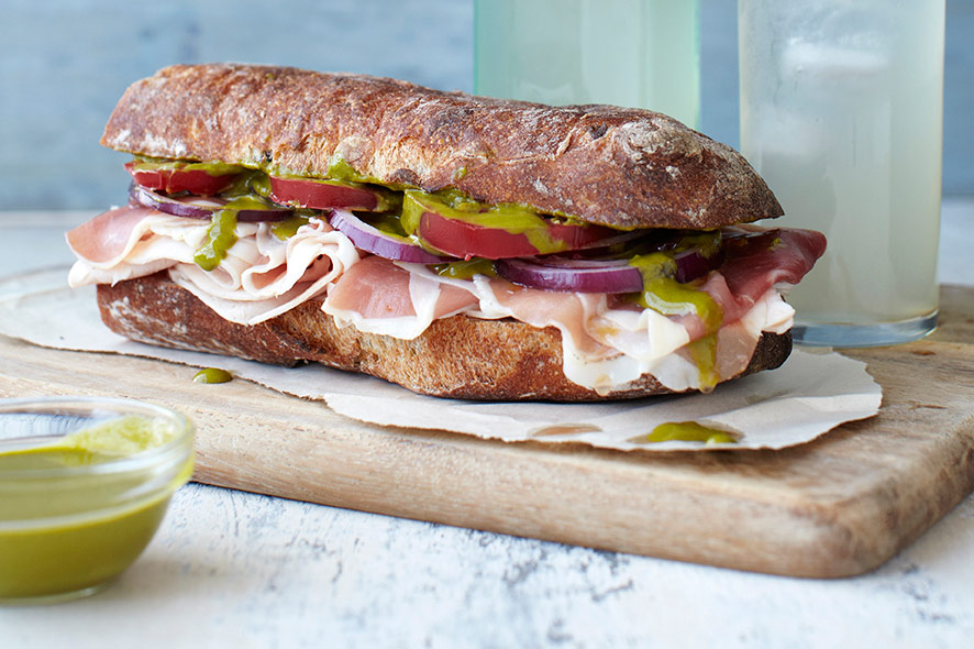 Prosciutto, turkey and tomato sandwich drizzled with Spring Greens