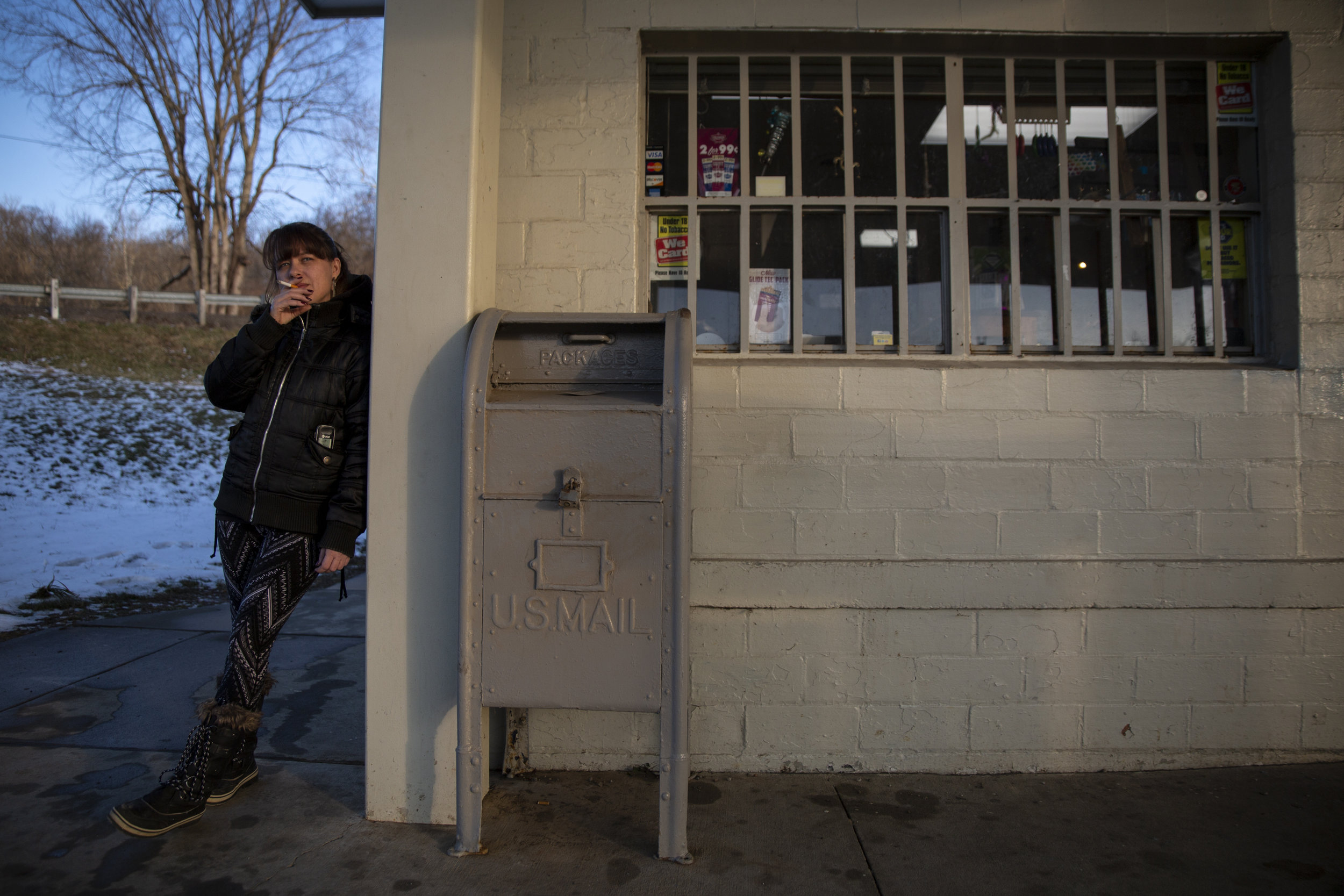  Brandy Riley takes a smoke break while working at Gilchrist Convenient Store, the only business remaining in the unincorporated community of Sharpsburg. This store and gas station also operates as a U.S. Post Office for everyone in the 45777 Sharpsb