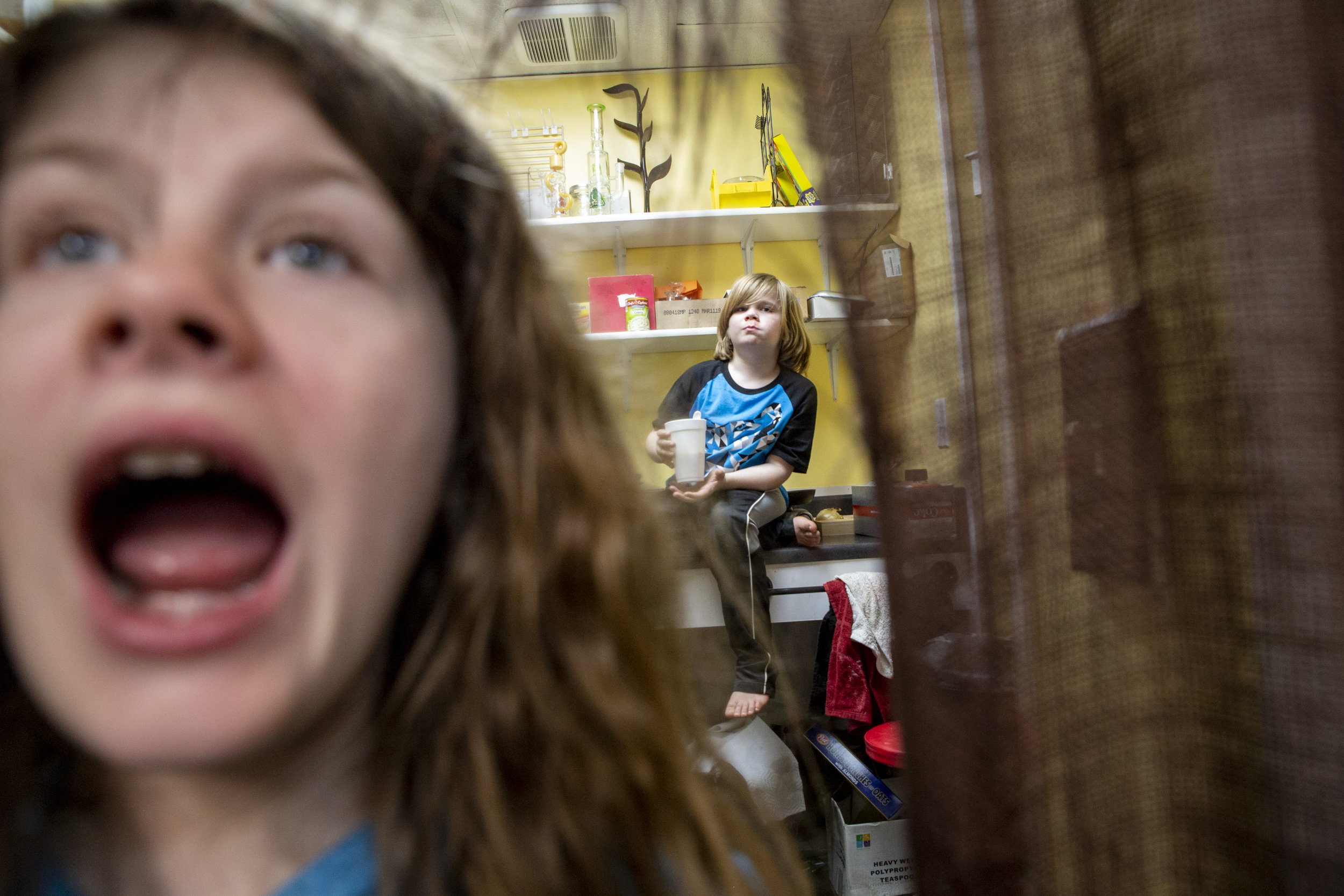  Siblings Lizzy, 10, and Adam Gilchrist, 6, get ready for school in the back kitchen of Gilchrist Convenient Store every morning. “They were raised here,” said their father Alan Gilchrist, who also grew up playing and working in the family store. 