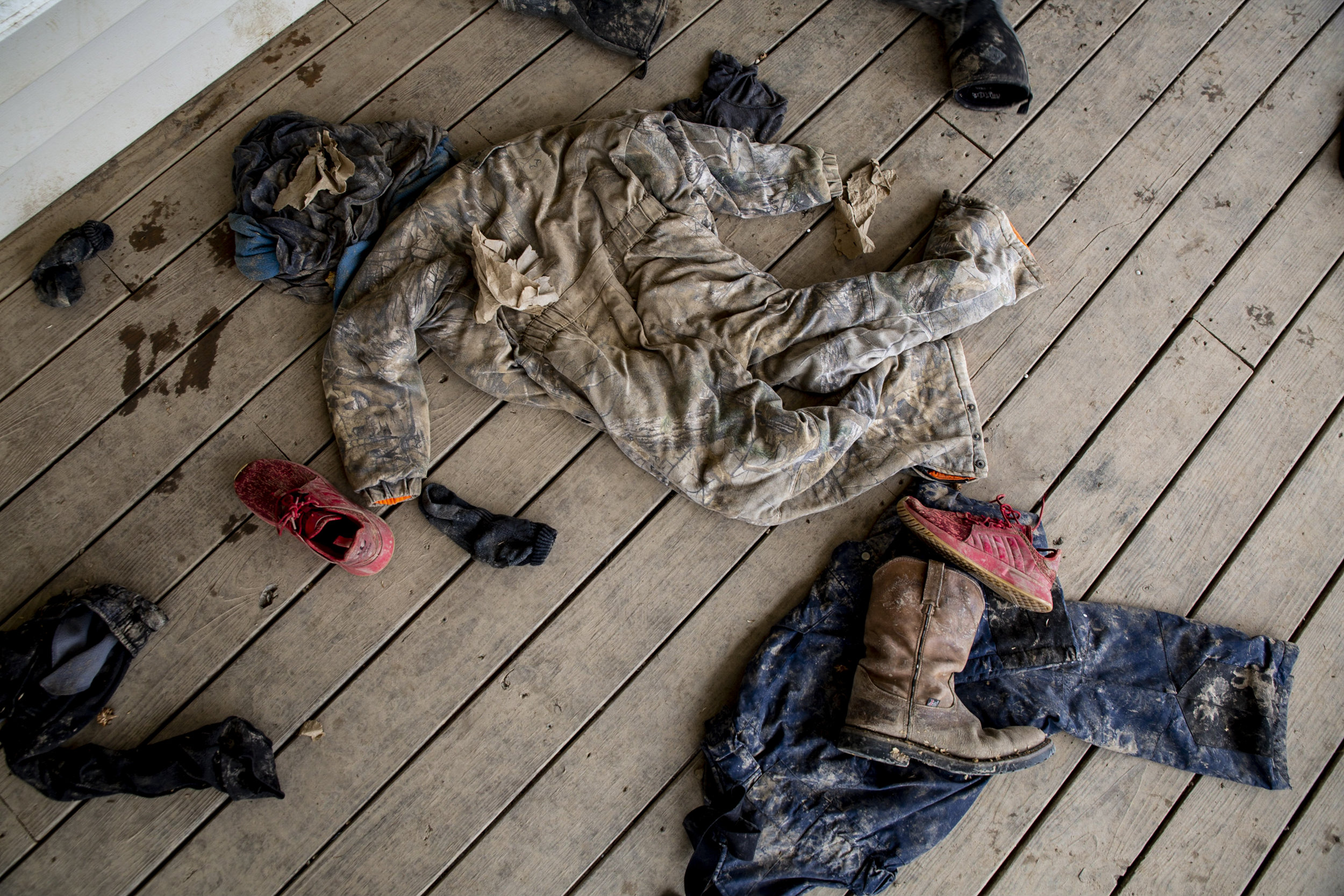  Muddy clothes adorn the porch of Nick and Tricia Russell's home. “I can’t do a house with a yard and people living next door to me,” said Nick Russell, who grew up in Sharpsburg and is now raising his sons there. 