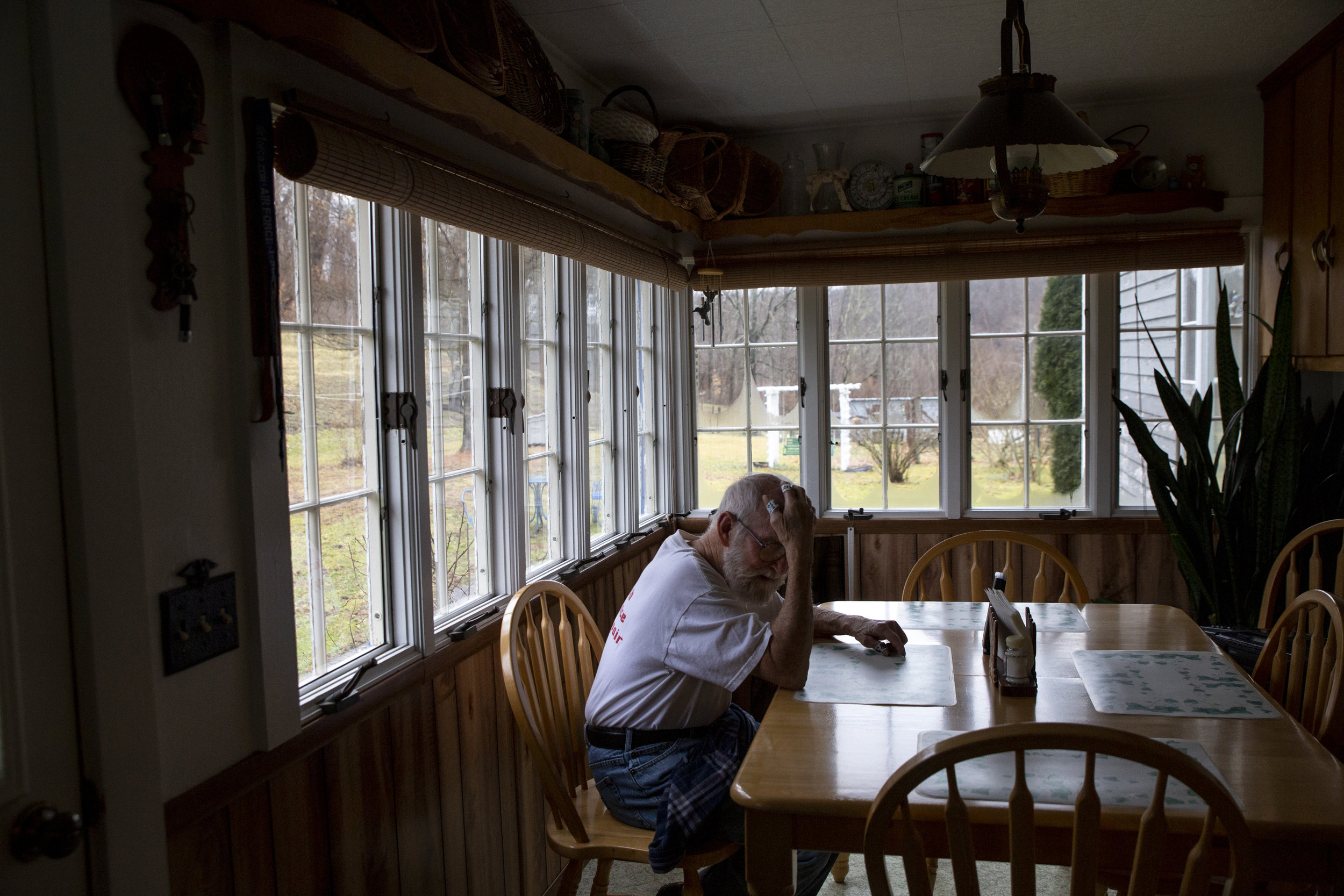  Bobby Spaulding, 82, rests in his kitchen after feeding his 15 cattle. Although he is battling cancer for a second time, Spaulding continues to raise cattle with his wife in order to afford their home. While he would like to sell the farm, his wife 