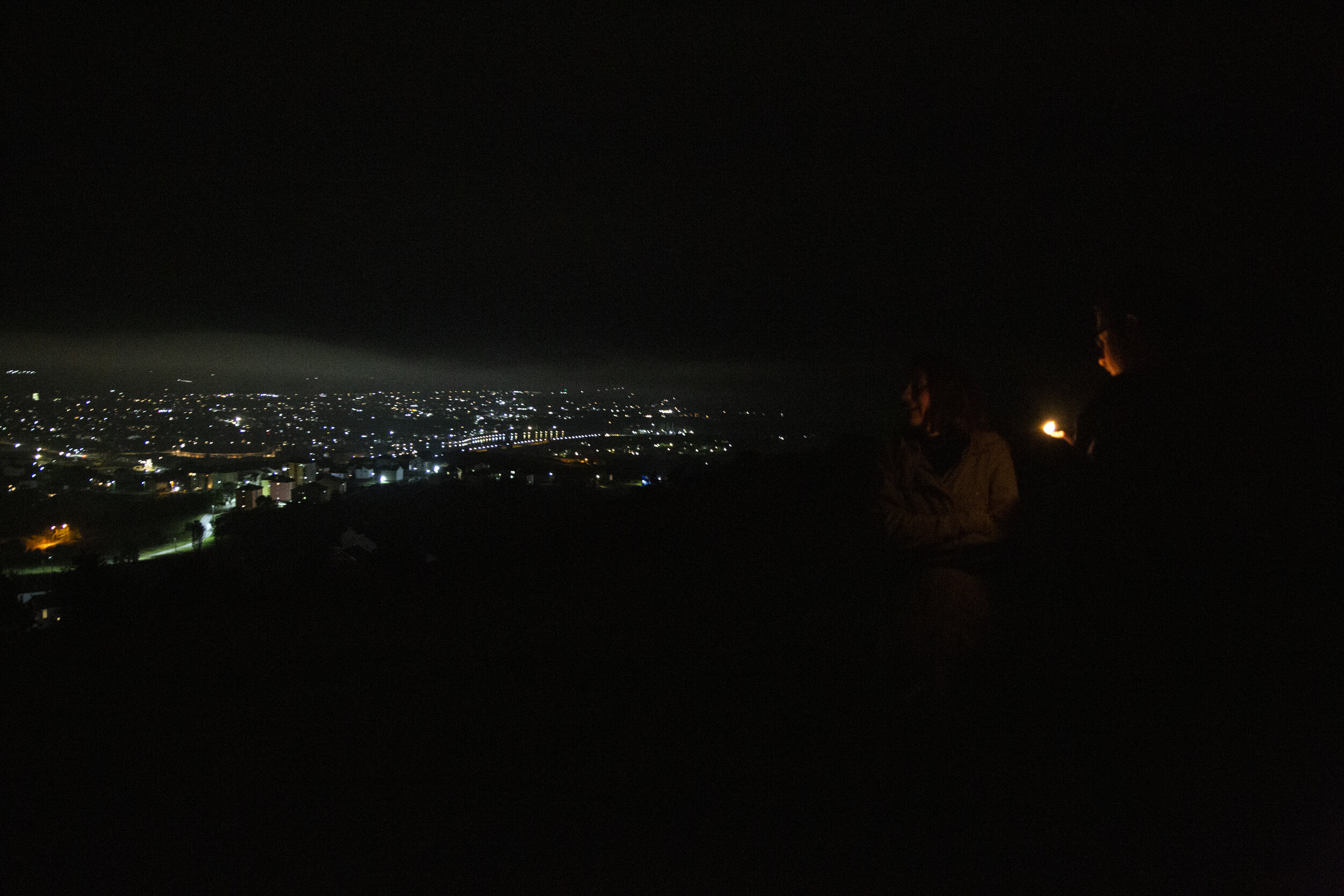  A young couple smokes weed above the lights of Mitrovica at night. There are no official reports on drug use in Mitrovica, but it's more accessible for young people to buy drugs than to go to the cinema. 