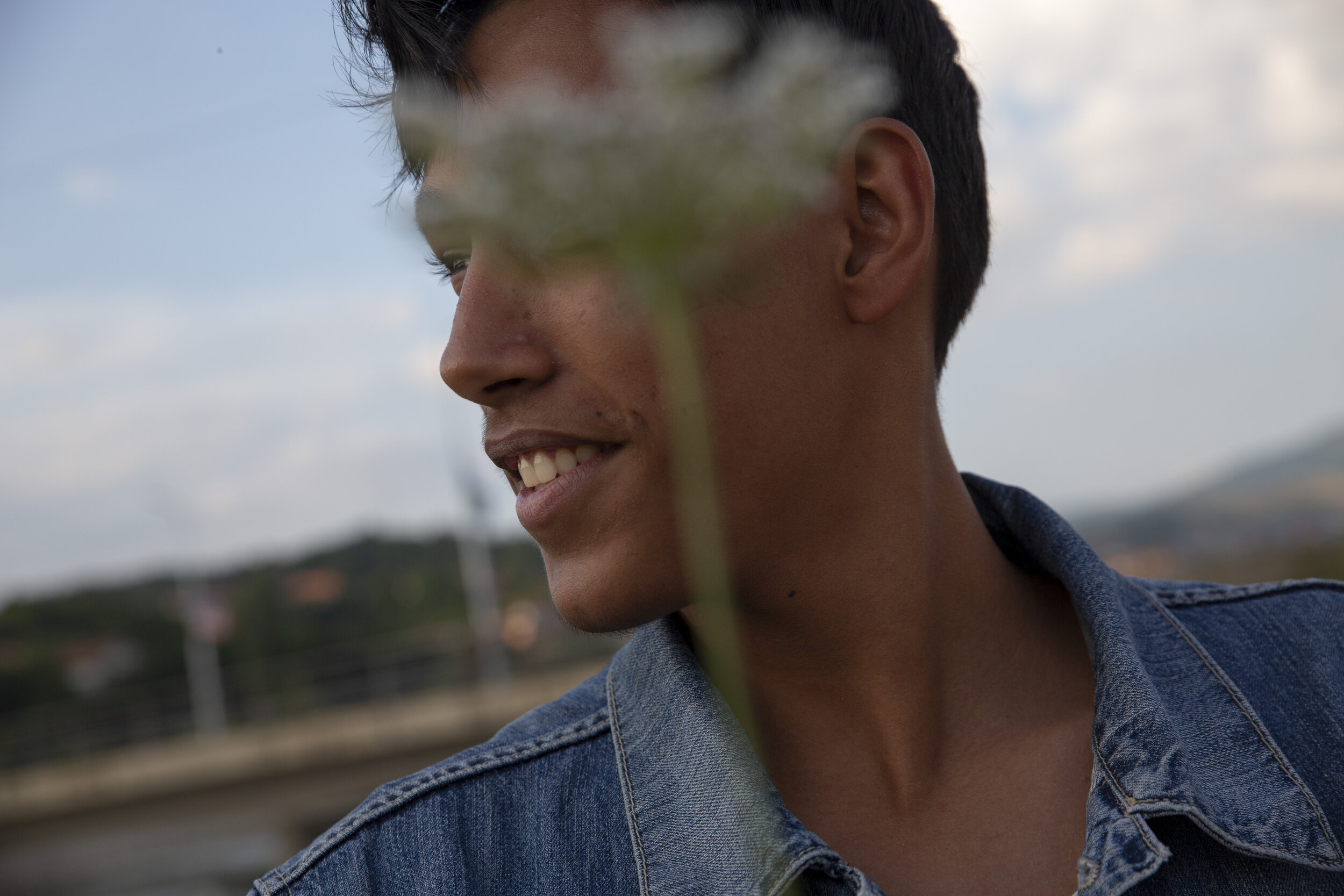  Zuki Beqiri, 17, picks a flower along the lake in South Mitrovica near Roma Mahala where he lives with his family. Zuki wants to stay in Kosovo, and to become a famous singer and rapper.  