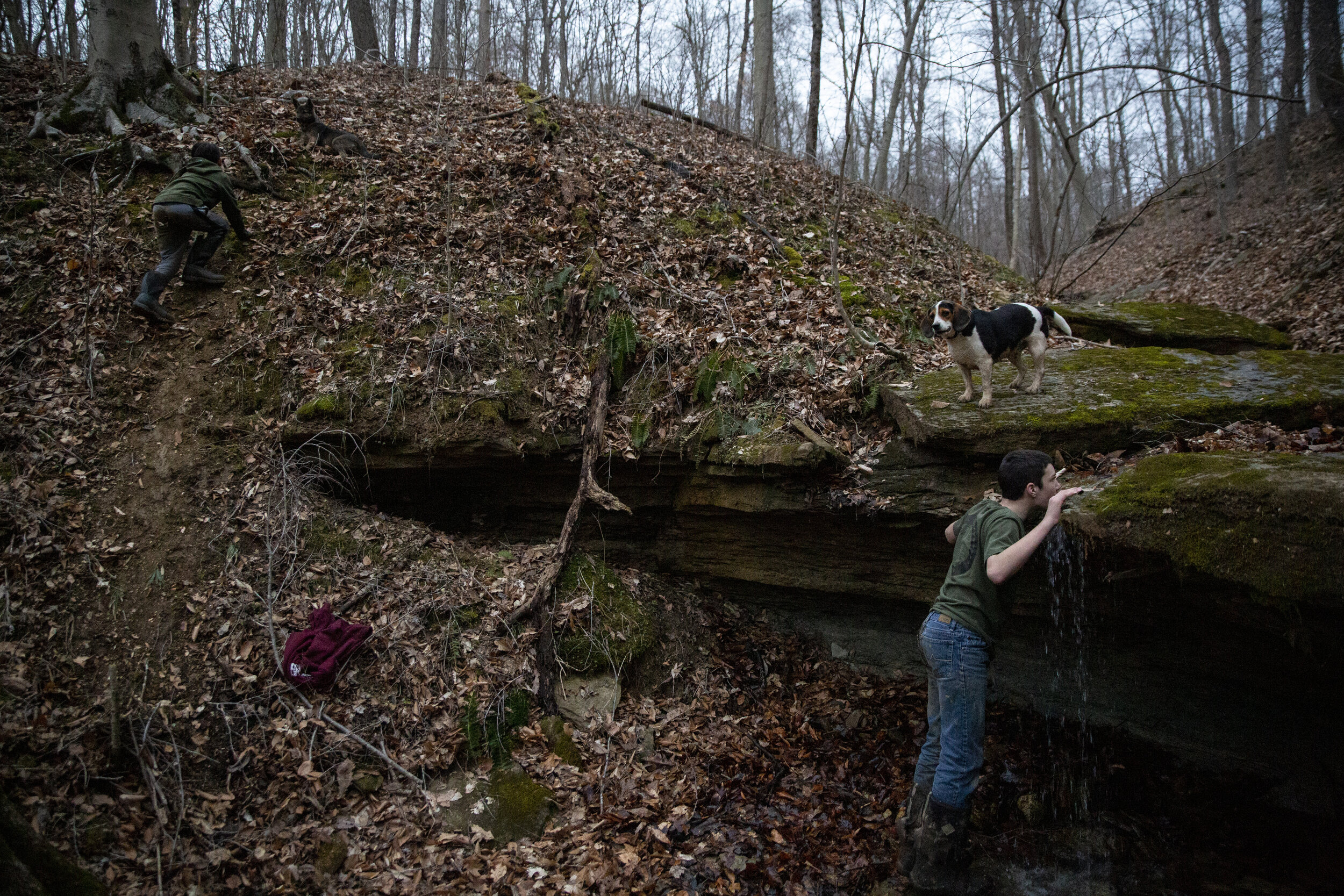  Riley Russell, 13, right, drinks from a stream on his family's property, which used to be mined for coal, while his brother Court, 10, runs uphill. Sharpsburg was an active coal-mining town until the mid-20th century. There have been efforts to resu
