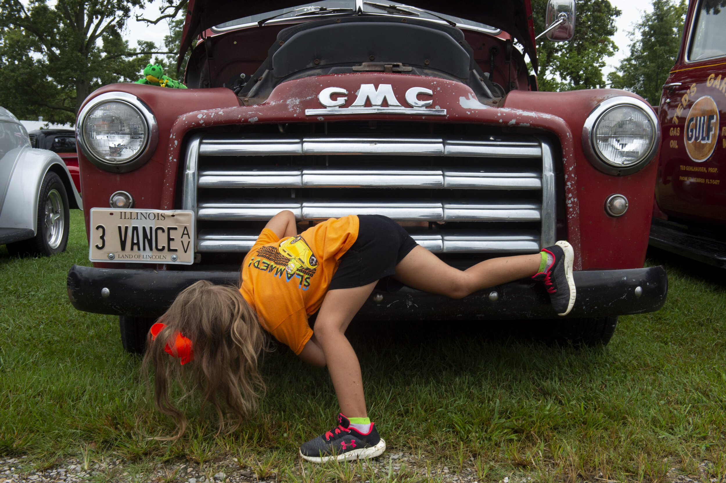  Faith Vance, 4, of Mount Vernon, Ill., looks underneath her father Quinton Vance's 1948 GMC at the 45th annual Frogs Follies held at Vanderburgh 4-H Center in Evansville, Friday afternoon, Aug. 23, 2019. 