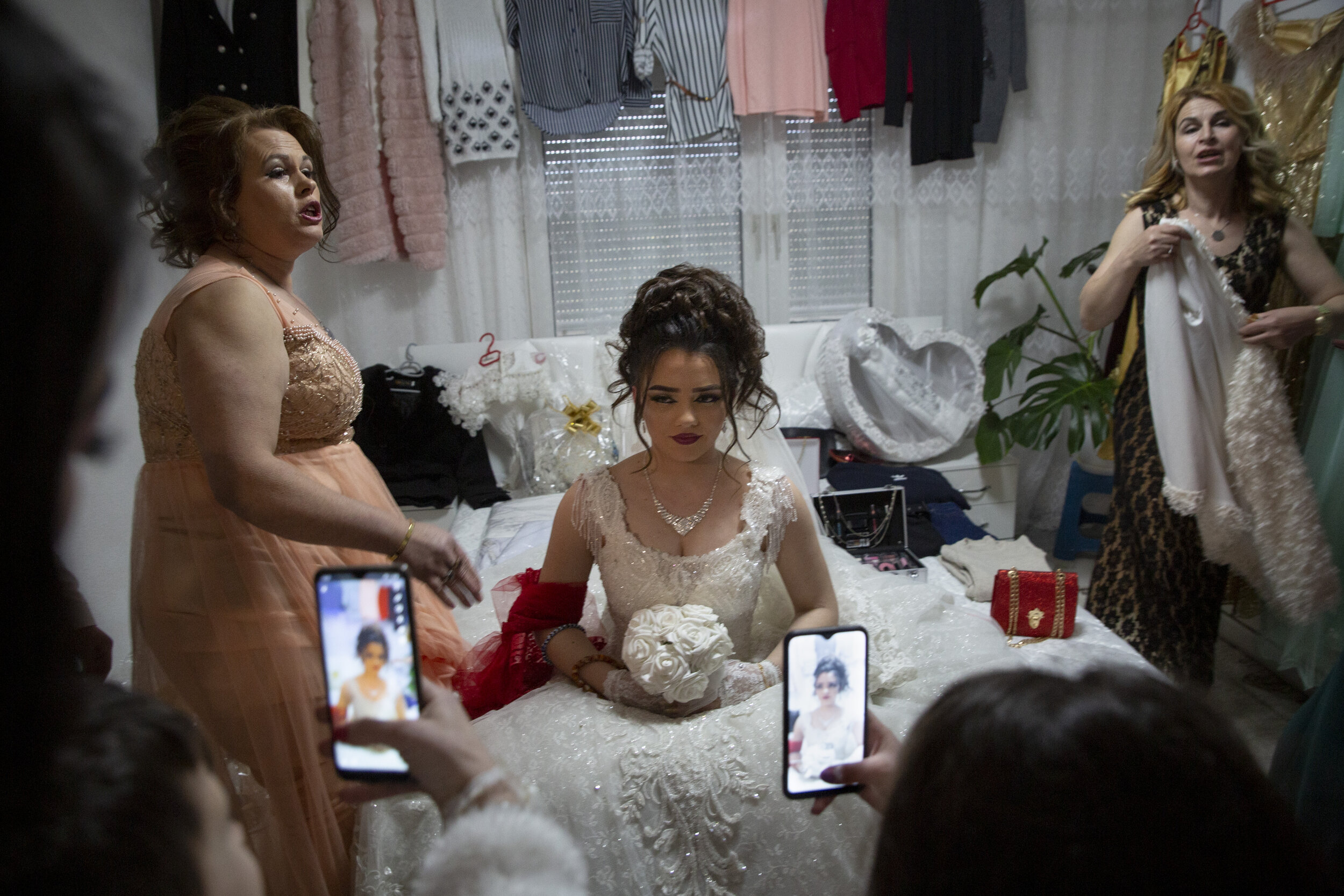  Qendresa Hasani, 16, sits patiently while her groom’s family video calls relatives abroad on Hasani’s wedding day, in her husband’s village outside of Mitrovica, Kosovo. In Kosovo, the minimum age to legally marry drops from 18 to 16 with parental c