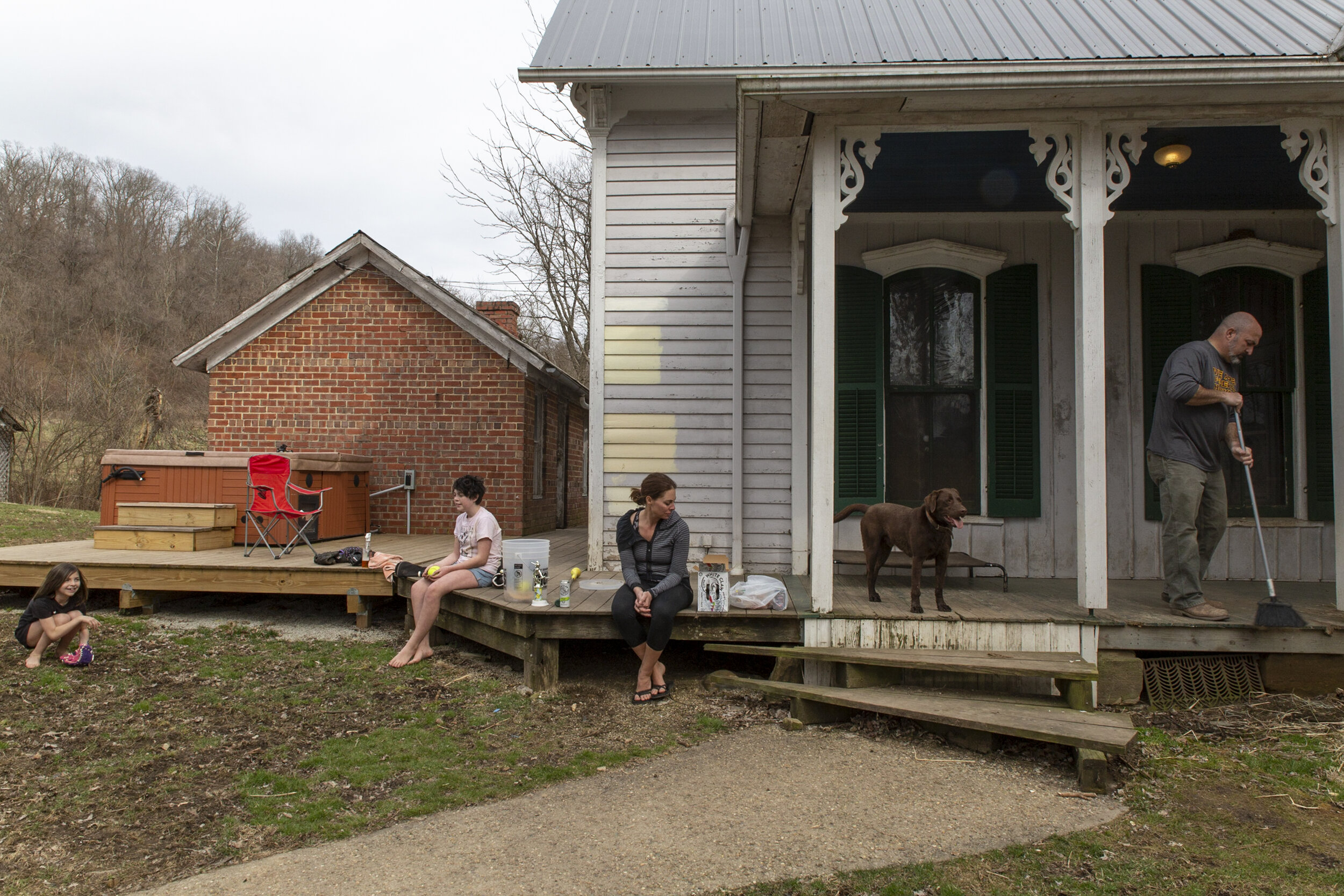  From left: Avalyn, 8, Ellery, 11, Ashley and Jeff Ditty, and their dog Cleveland, spend the evening outside their home, a farm house built in the 1830s. They moved to Sharpsburg in 2015 to raise their daughters in a simple, slow-paced environment. “