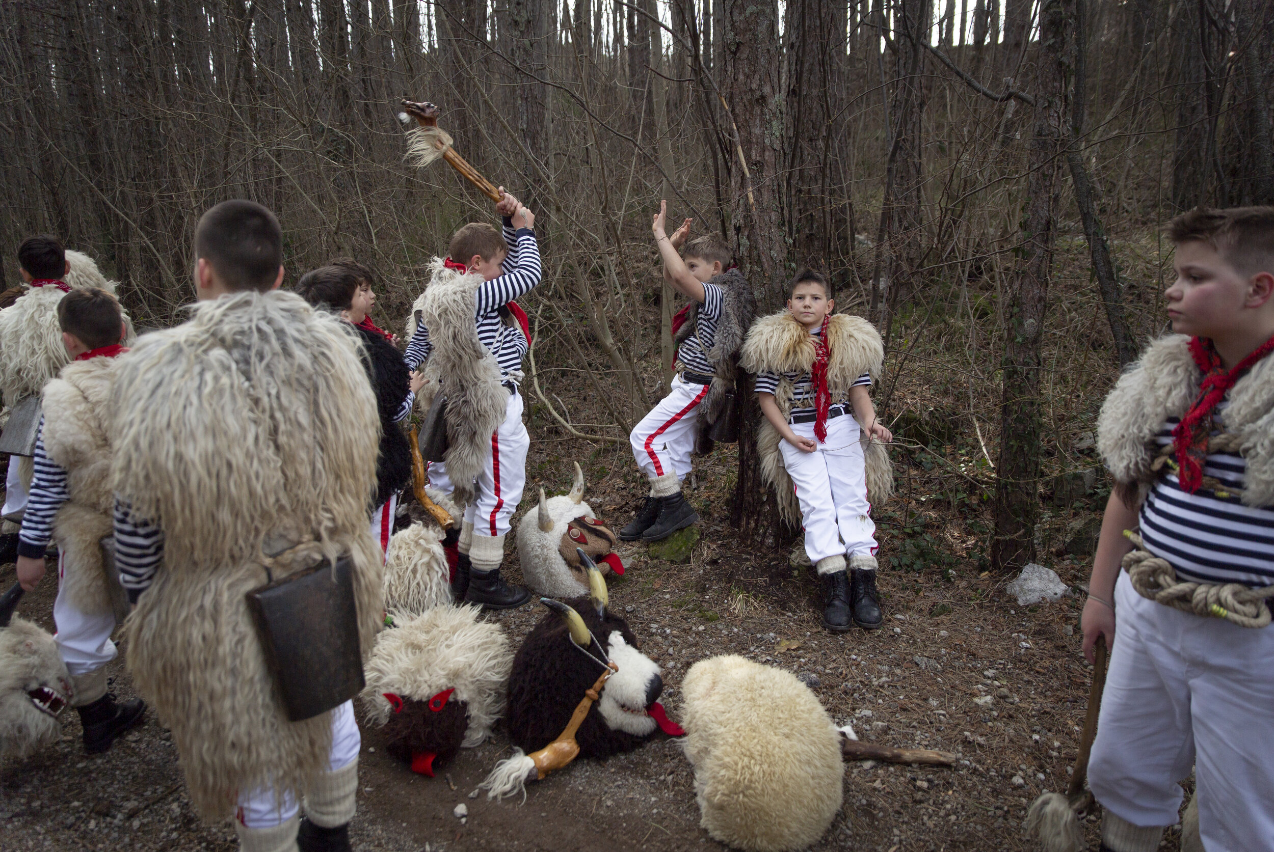  Young Halubajski zvončari take a break while walking in the woods. This custom, which dates back to pre-Christian times, is passed down to boys as young as 2 years old. The some 250 men who currently participate in these festivities hope to continue