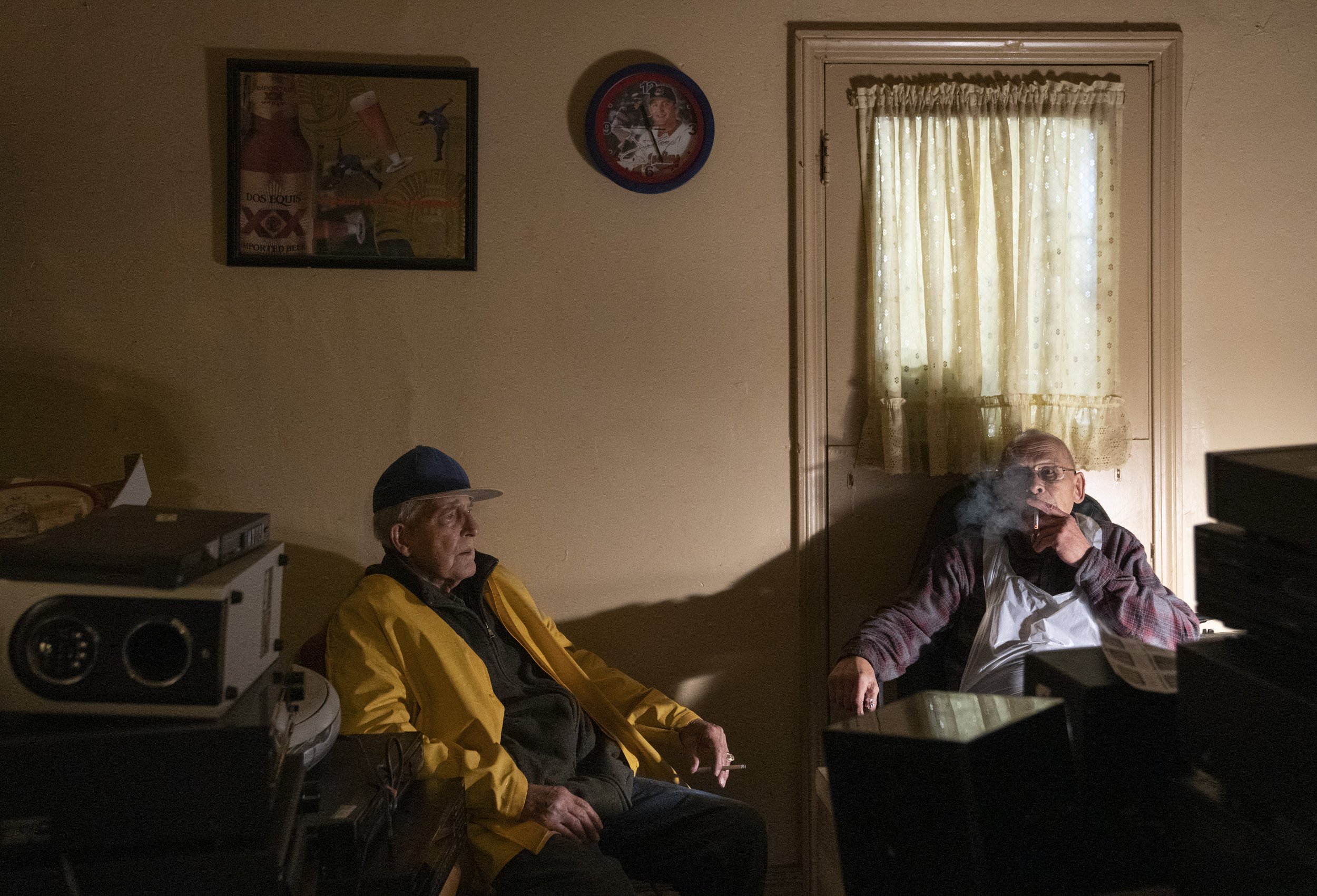  After processing sausage, Raymond Smerritt, left, and Vince Zachary take a smoke break in the office behind Azman &amp; Sons Market in Cleveland, Ohio, Oct. 14, 2020.  